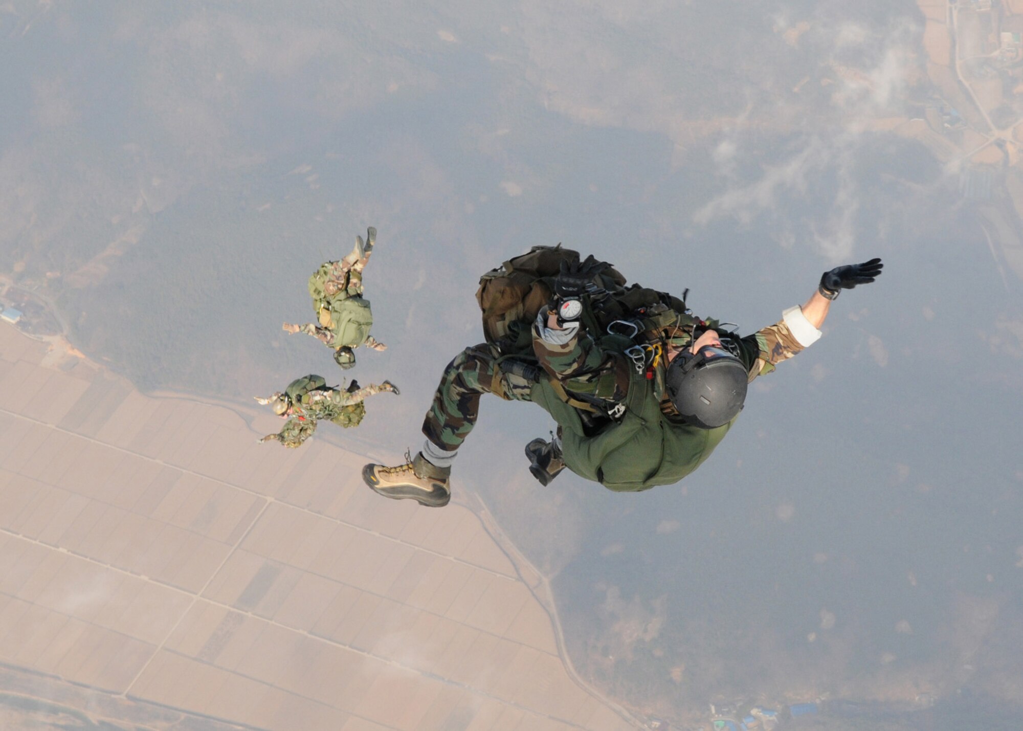 DAEGU AIR BASE, Republic of Korea -- Members from the 320th Special Tactics Squadron freefall after jumping from the back of a 1st Special Operations Squadron MC-130H Combat Talon II here March 19. The high altitude, low opening jump training is in preparation for the group's annual operational readiness exercise which affords unit members an opportunity to practice wartime skills necessary for their ability to survive and operate. The 353rd Special Operations Group is the focal point for all U.S. Air Force special operations activities throughout the U.S. Pacific Command theater. (U.S. Air Force photo by Tech. Sgt. Aaron Cram)
