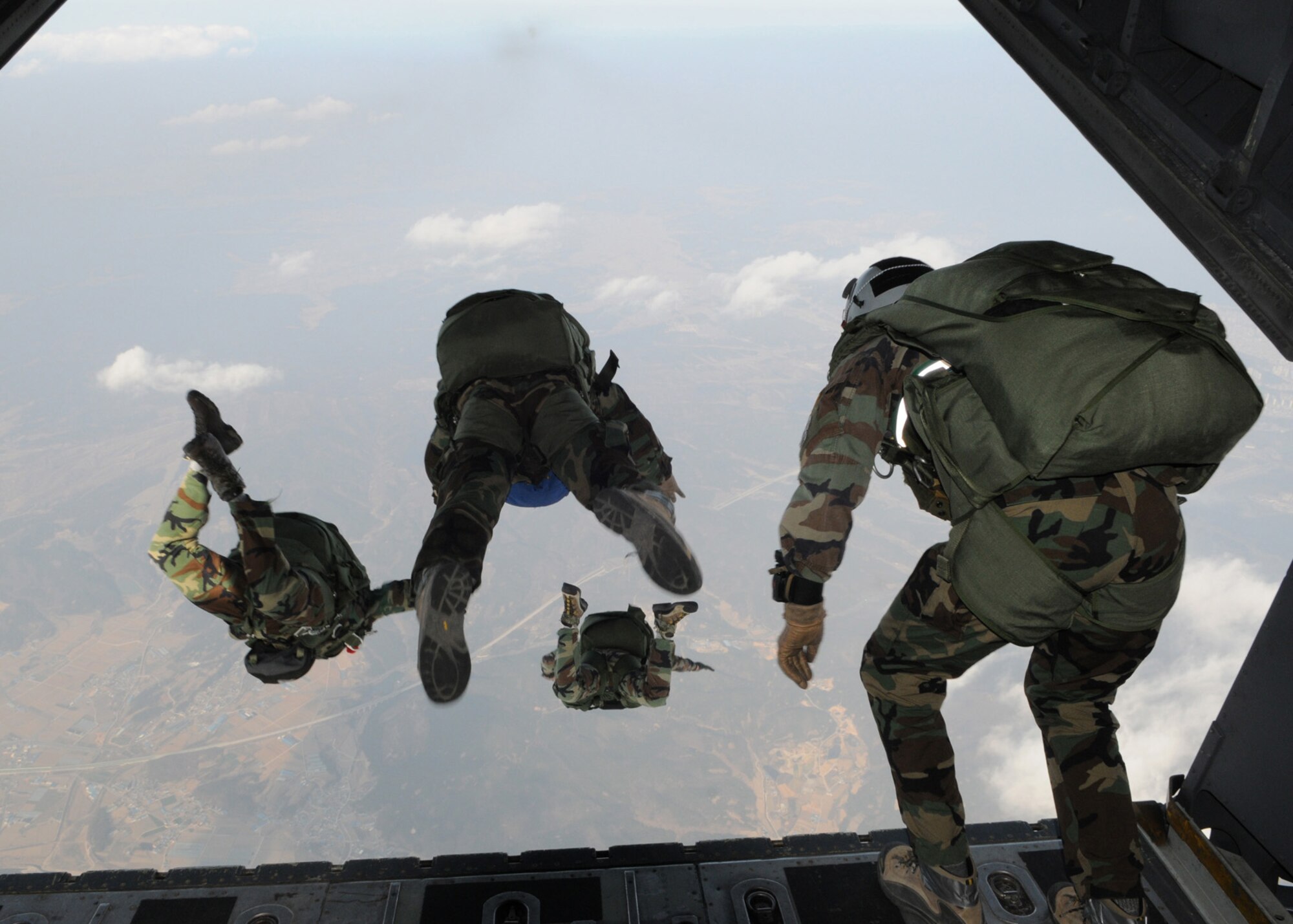 DAEGU AIR BASE, Republic of Korea -- Members from the 320th Special Tactics Squadron jump from the back of a 1st Special Operations Squadron MC-130H Combat Talon II here March 19. The high altitude, low opening jump training is in preparation for the group's annual operational readiness exercise which affords unit members an opportunity to practice wartime skills necessary for their ability to survive and operate. The 353rd Special Operations Group is the focal point for all U.S. Air Force special operations activities throughout the U.S. Pacific Command theater. (U.S. Air Force photo by Tech. Sgt. Aaron Cram)
