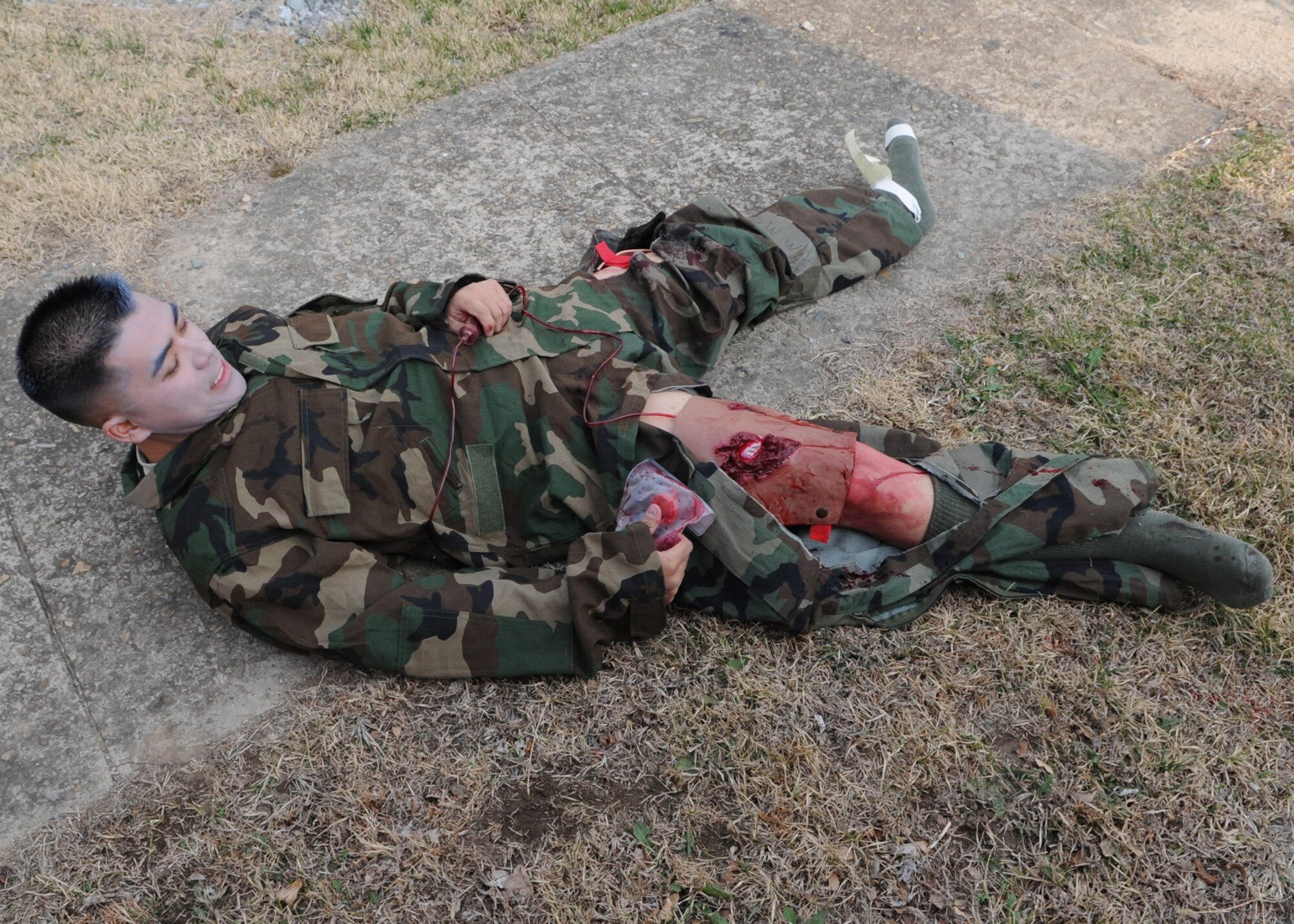 DAEGU AIR BASE, Republic of Korea -- Senior Airman Kevin Doan, a security forces member from the 353rd Operations Support Squadron, screams in agony to kick off a medical training exercise here March 18. The training is in preparation for the group's annual operational readiness exercise which affords unit members an opportunity to practice wartime skills necessary for their ability to survive and operate. The 353rd Special Operations Group is the focal point for all U.S. Air Force special operations activities throughout the U.S. Pacific Command theater. (U.S. Air Force photo by Tech. Sgt. Aaron Cram)
