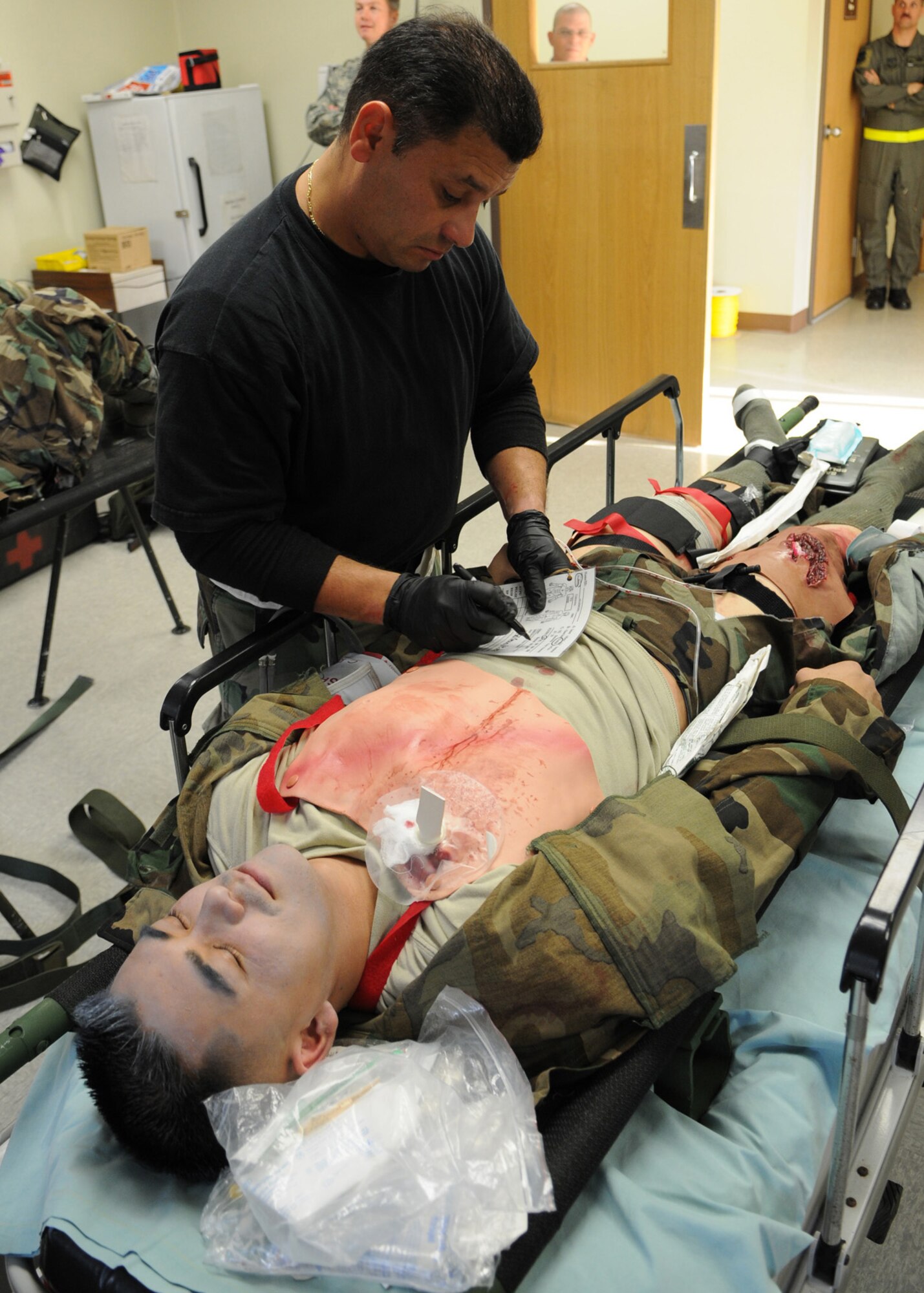 DAEGU AIR BASE, Republic of Korea -- Tech. Sgt. Sixto Vargas, from the 353rd Operations Support Squadron Medical Flight, fills out a patient transfer card during medical training exercise here March 18. The training is in preparation for the group's annual operational readiness exercise which affords unit members an opportunity to practice wartime skills necessary for their ability to survive and operate. The 353rd Special Operations Group is the focal point for all U.S. Air Force special operations activities throughout the U.S. Pacific Command theater. (U.S. Air Force photo by Tech. Sgt. Aaron Cram)