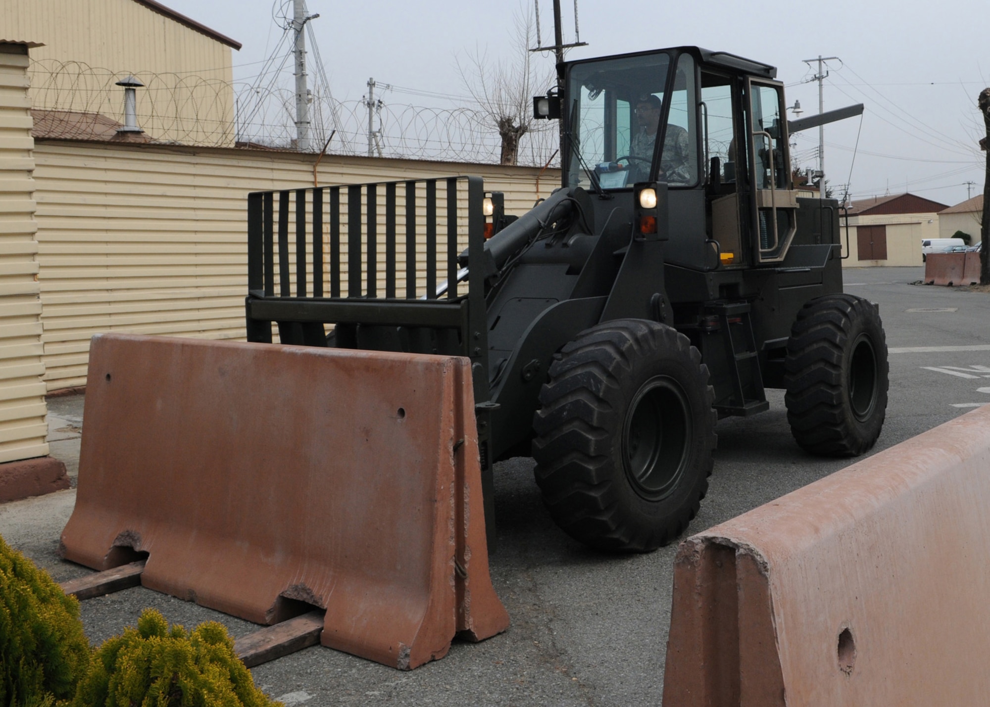 DAEGU AIR BASE, Republic of Korea -- Staff Sgt. Michael Berish, a security forces member with the 353rd Operations Support Squadron, moves a concrete barrier here March 12 in preparation for the 353rd Special Operations Group's annual operational readiness exercise which affords unit members an opportunity to practice wartime skills necessary for their ability to survive and operate. The 353rd Special Operations Group is the focal point for all U.S. Air Force special operations activities throughout the U.S. Pacific Command theater. (U.S. Air Force photo by Tech. Sgt. Aaron Cram)