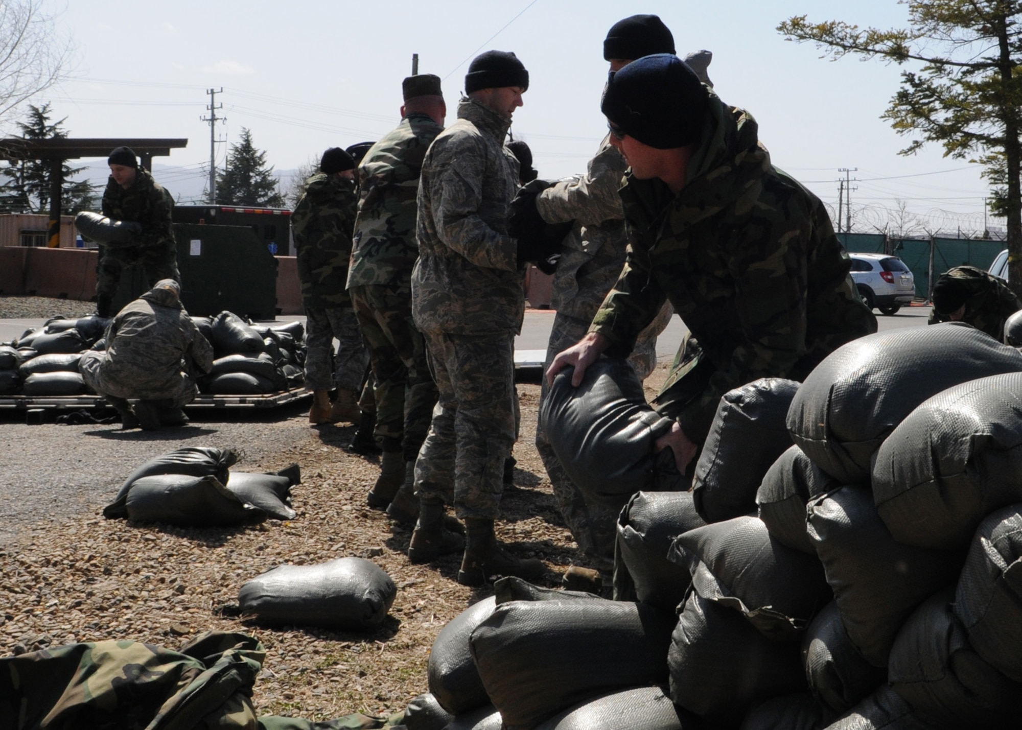 DAEGU AIR BASE, Republic of Korea -- Members of the 353rd Special Operations Group move sandbags to a pallet here March 14. The sandbags will be used for various purposes during the group's annual operational readiness exercise which affords unit members an opportunity to practice wartime skills necessary for their ability to survive and operate. The 353rd Special Operations Group is the focal point for all U.S. Air Force special operations activities throughout the U.S. Pacific Command theater. (U.S. Air Force photo by Tech. Sgt. Aaron Cram)
