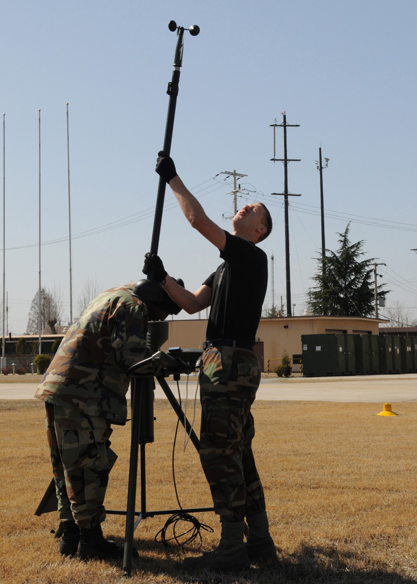 DAEGU AIR BASE, Republic of Korea -- Staff Sgt. Roderic Jackson (left) and Senior Airman Steven Yount, both from the 353rd Operations Support Squadron Weather Flight, put up a TMQ-53 Tactical Weather Observation System here March 14. The system reads key weather indicators used to provide accurate forecasts that will be used during the group's annual operational readiness exercise which affords unit members an opportunity to practice wartime skills necessary for their ability to survive and operate. The 353rd Special Operations Group is the focal point for all U.S. Air Force special operations activities throughout the U.S. Pacific Command theater. (U.S. Air Force photo by Tech. Sgt. Aaron Cram)

