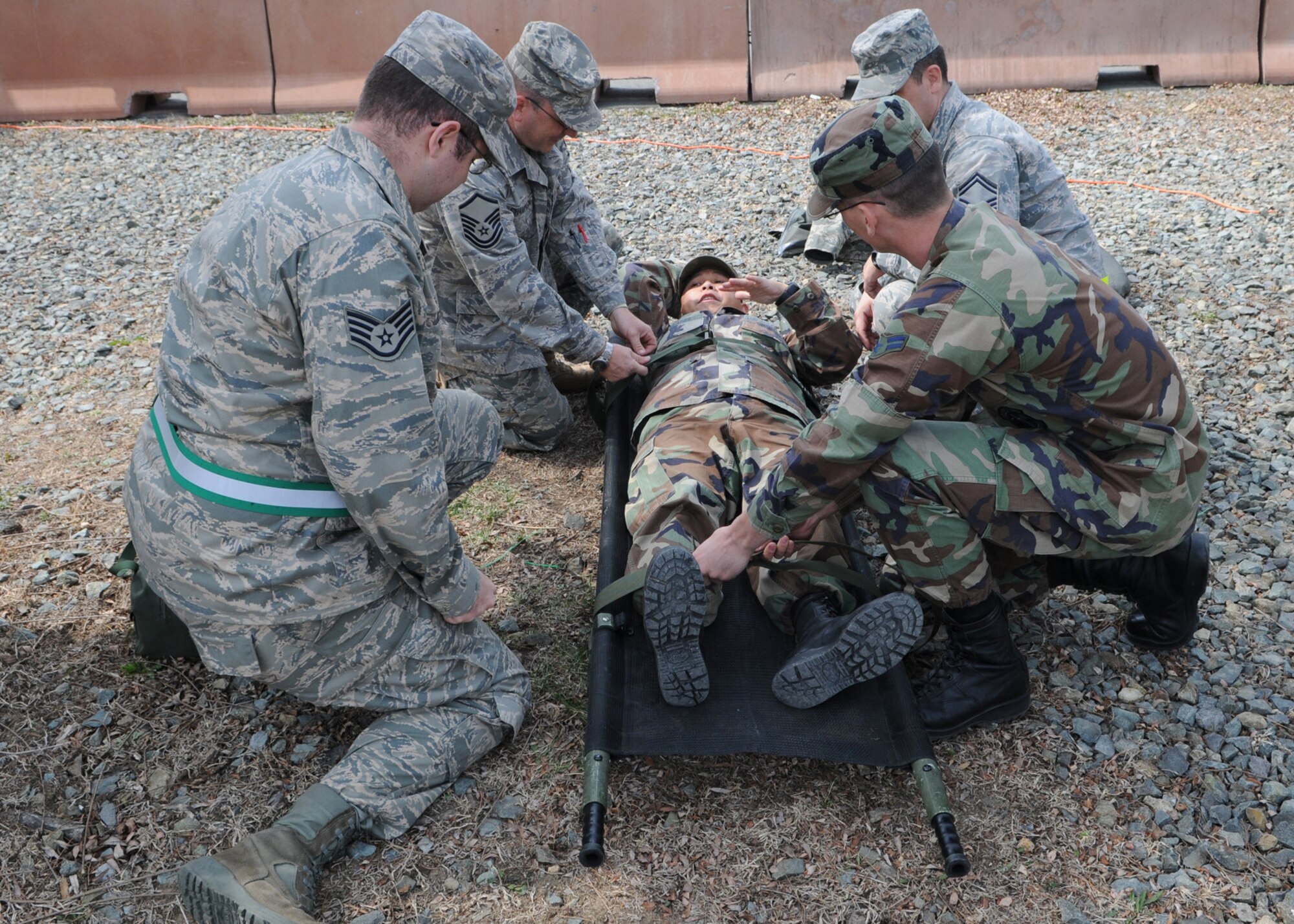 DAEGU AIR BASE, Republic of Korea -- Tech. Sgt. Jose Llanes (on stretcher), from the 353rd Operations Support Squadron Medical Flight, instructs members of the 353rd Special Operations Group on how to properly secure a patient to a stretcher during training here March 16. The training is in preparation for the group's annual operational readiness exercise which affords unit members an opportunity to practice wartime skills necessary for their ability to survive and operate. The 353rd Special Operations Group is the focal point for all U.S. Air Force special operations activities throughout the U.S. Pacific Command theater. (U.S. Air Force photo by Tech. Sgt. Aaron Cram)