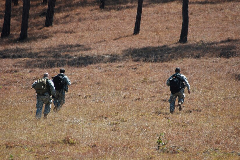 U.S. Army Soldiers run to the treeline after a simulated helicopter crash during an exercise near La Paz, Honduras, March 20. Eighteen members of the 1st Battalion, 228th Aviation Regiment, assigned to Joint Task Force-Bravo here, took part in the day-long training exercise. The training sharpened land navigation, communication equipment, and aircraft vectoring skills. (U.S. Air Force photo/Tech. Sgt. Mike Hammond)