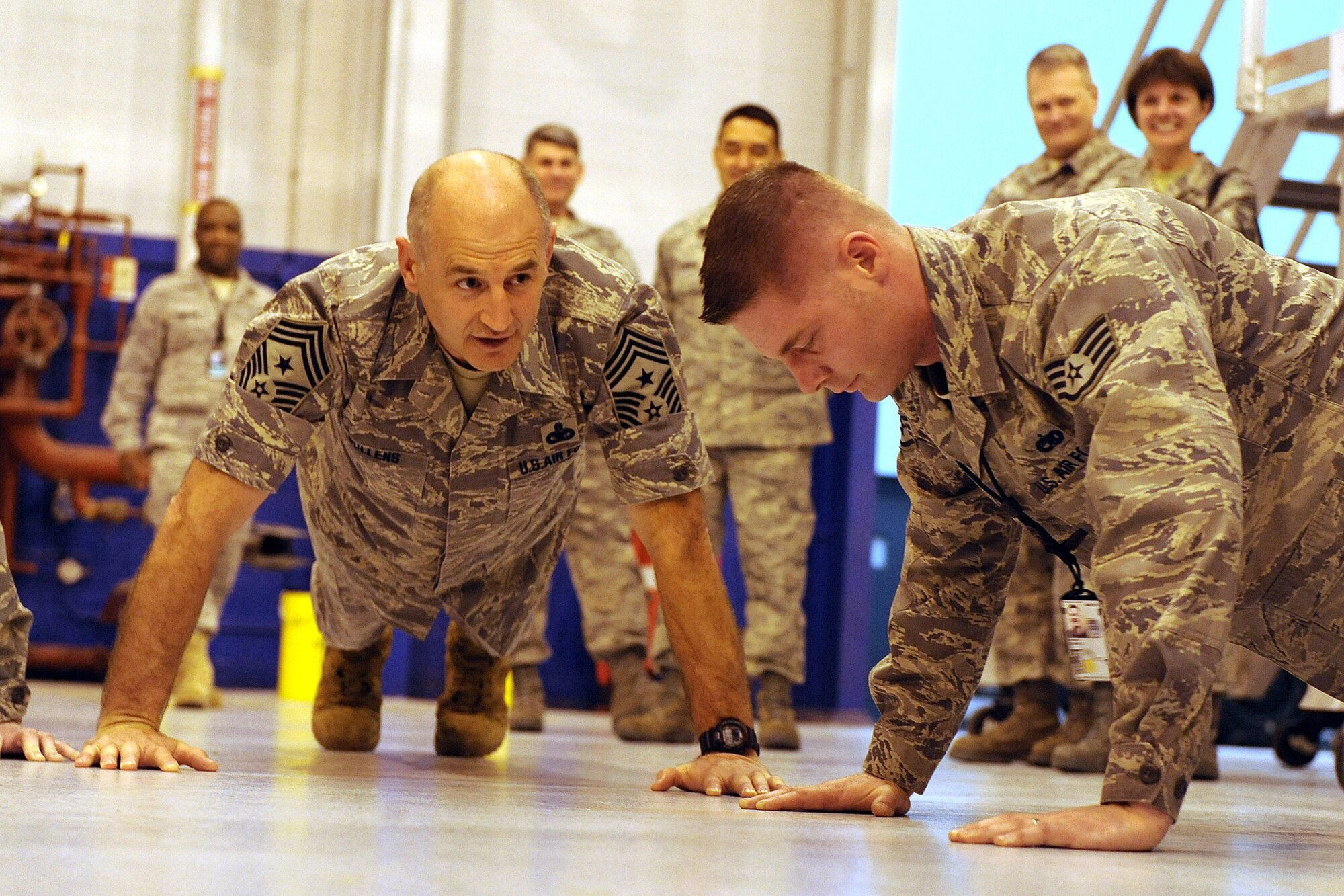 OFFUTT AIR FORCE BASE, Neb. -- Air Combat Command's Command Chief Master Sgt. Stephen C. Sullens challenges Staff Sgt. Bernie Rowe, 55th Maintenance Squadron, to do 30 pushups with him after stressing the importance of physical fitness for airman, inside of Dock Three of the Bennie Davis Maintenance Facility, Mar 19.  The Chief toured various facilities as part of a two day visit to get better acquainted with both the mission and Airmen of the "Fighting Fifty Fifth."
U.S. Air Force Photo by Josh Plueger
