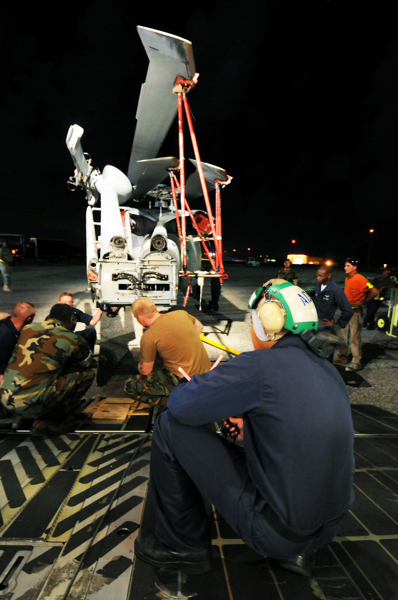 Airmen from the West Virginia Air National Guard's 167th Airlift Wing and the 734th Air Mobility Squadron at Anderson Air Force Base, Guam, along with Sailors from Helicopter Sea Combat Squadron TWO-FIVE at Guam's A.B. Won Pat International Airport load three MH-60S Knighthawks and two SH-60H Sea Hawks onto a C-5 Galaxy March 13 at Andersen AFB.  The helicopters were being transported to Naval Air Station North Island in San Diego. (U.S. Air Force photo/Airman 1st Class Courtney Witt) 