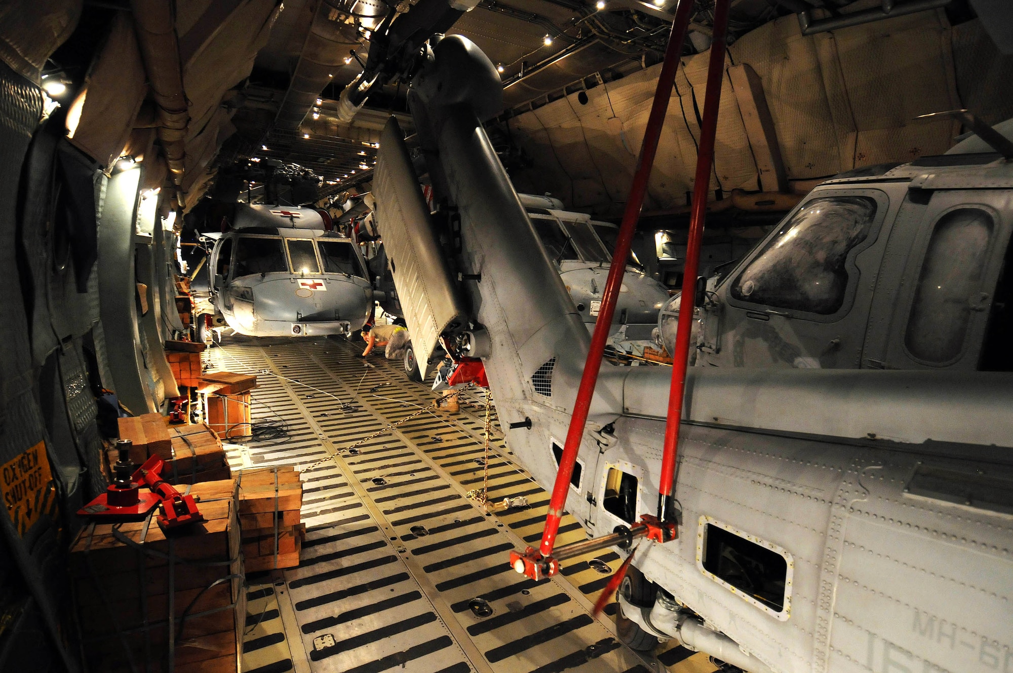 Airmen from the West Virginia Air National Guard's 167th Airlift Wing and the 734th Air Mobility Squadron at Anderson Air Force Base, Guam, along with Sailors from Helicopter Sea Combat Squadron TWO-FIVE at Guam's A.B. Won Pat International Airport load three MH-60S Knighthawks and two SH-60H Sea Hawks onto a C-5 Galaxy March 13 at Andersen AFB.  The helicopters were being transported to Naval Air Station North Island in San Diego. (U.S. Air Force photo/Airman 1st Class Courtney Witt) 
