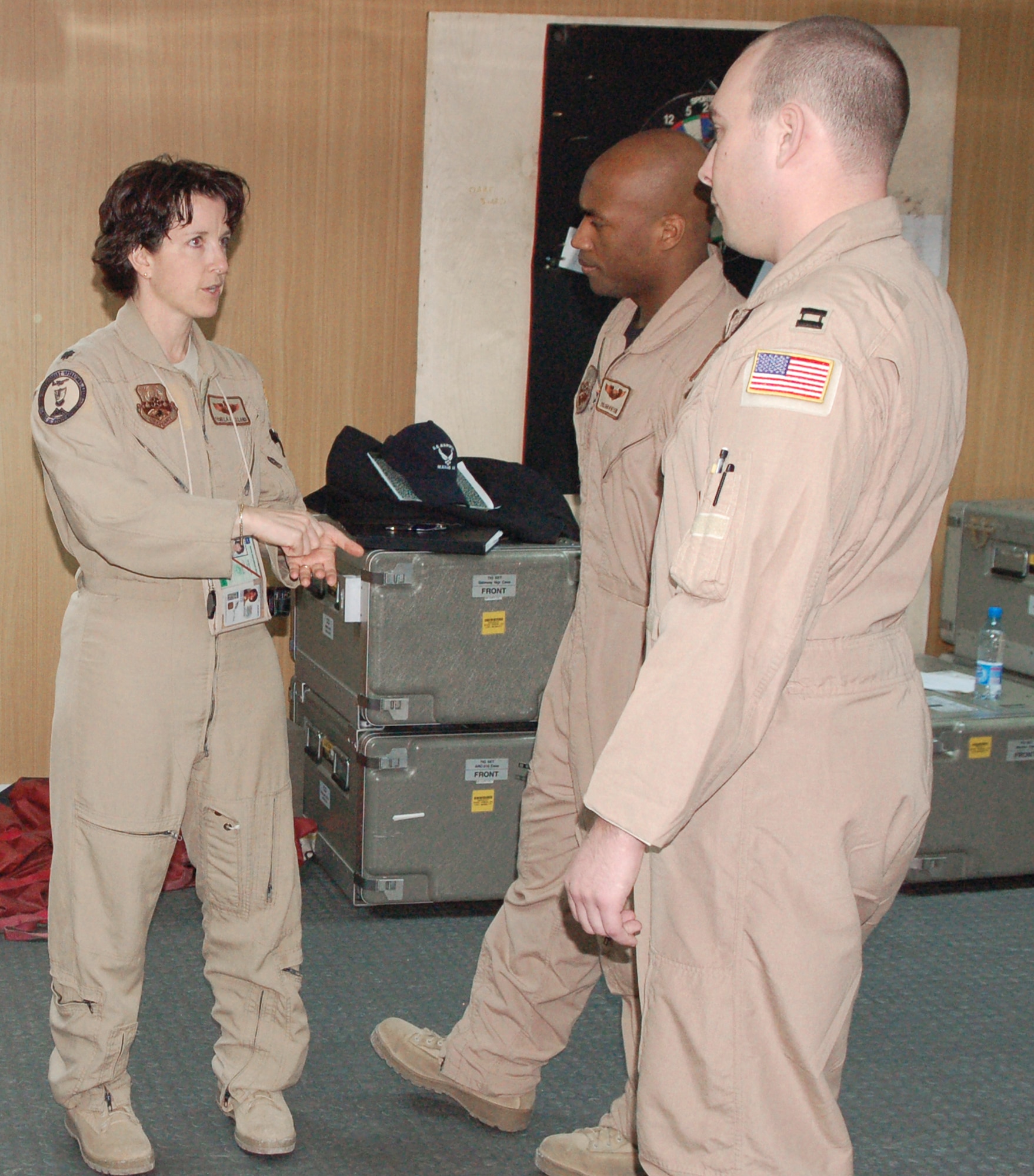 Lt. Col. Pamela Freeland explains the purpose and benefits of the Roll-On-Beyond-Line-Of-Sight Enhancement System to Capt. Julian Benton (rear) and Capt. Walter Hale March 13 at Manas Air Base, Kyrgyzstan. Both captains are KC-135 Stratotanker pilots deployed from the 92nd Air Refueling Squadron at Fairchild Air Force Base, Wash. Colonel Freeland is the chief of standardization and evaluation for the 376th Expeditionary Operations Group deployed from the 97th Training Squadron at Altus AFB, Okla. (U.S. Air Force photo/Maj. Damien Pickart) 
