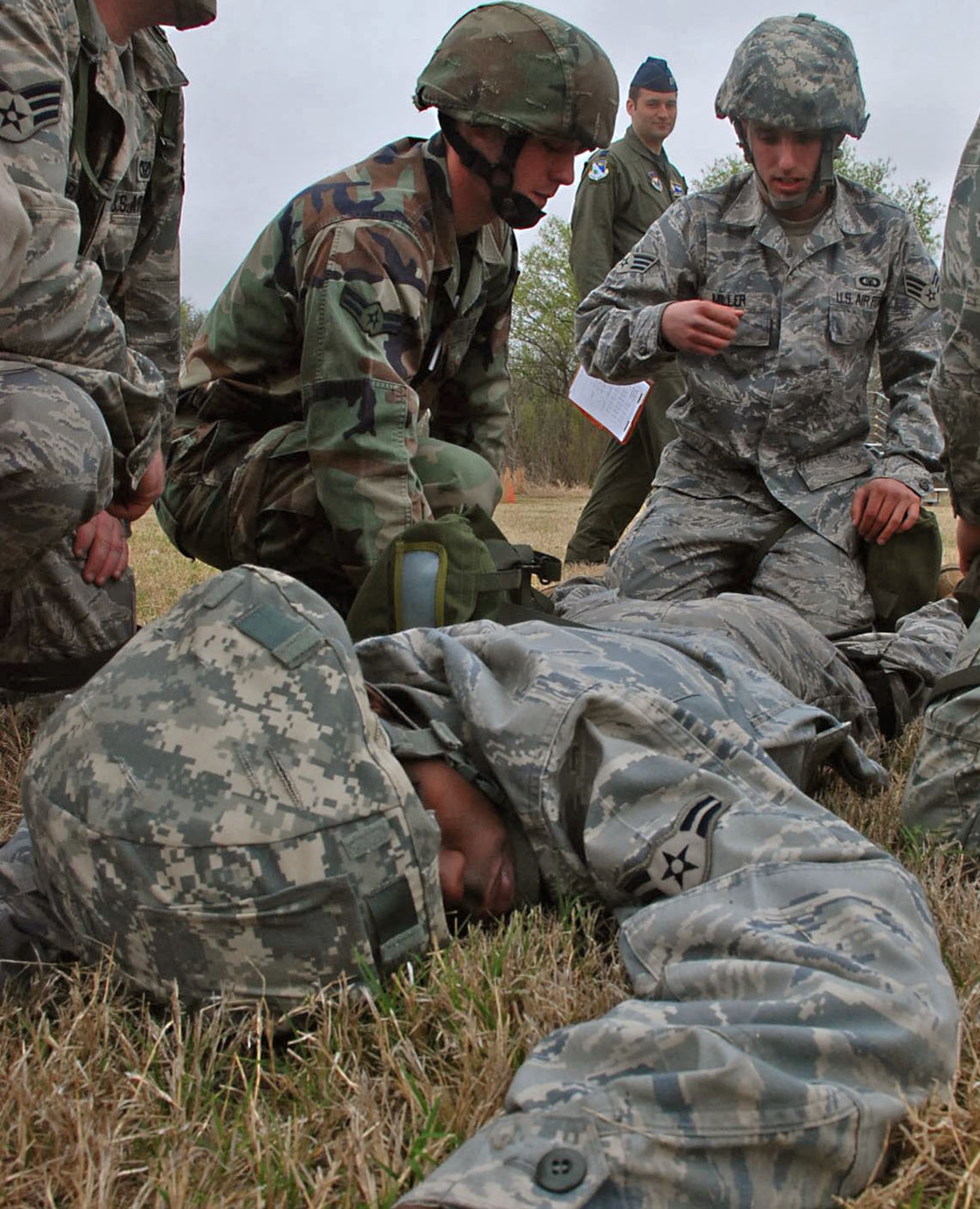 LAUGHLIN AIR FORCE BASE, Texas –A team of Airmen tend to a simulated patient while leaders of critique their performance during the Ability To Survive and Operate exercise here March 18. The ATSO exercise consisted of more than 50 Laughlin Airmen working together to sharpen their war-fighting skills by completing different scenarios they could possibly face in a deployed location. (U.S. Air Force photo by Airman 1st Class Sara Csurilla)