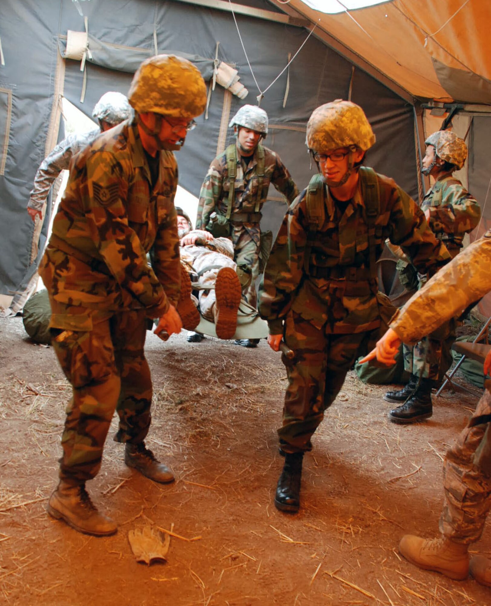 LAUGHLIN AIR FORCE BASE, Texas –A team of Airmen participate in the Ability To Survive and Operate exercise by bringing  a simulated patient into the ATSO medical tent here March 18. The ATSO exercise consisted of more than 50 Laughlin Airmen working together to sharpen their war-fighting skills by completing different scenarios they could possibly face in a deployed location. (U.S. Air Force photo by Airman 1st Class Sara Csurilla)