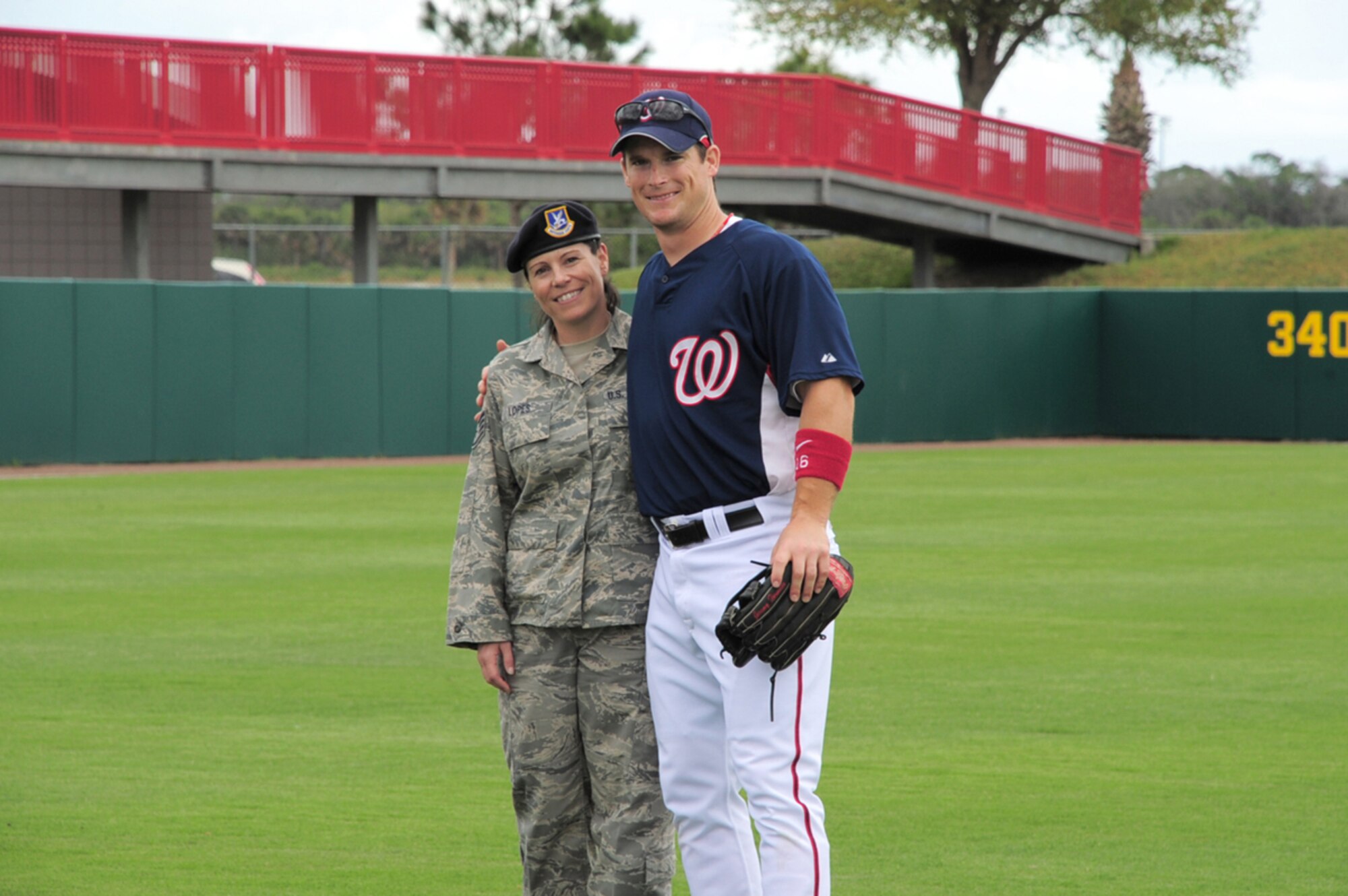 PATRICK AIR FORCE BASE, Fla. - Purple Heart recipient Staff Sgt. Diane Lopes, security forces specialist, 920th Rescue Wing here, poses with Washington Nationals outfielder Josh Willingham during pre-game ceremonies at the Space Coast Stadium in central Florida.  Military members were invited to stand with players in honor of military appreciation day March 19.  The Nationals beat the Orioles, 5-4. (Photo/Capt. Cathleen Snow)