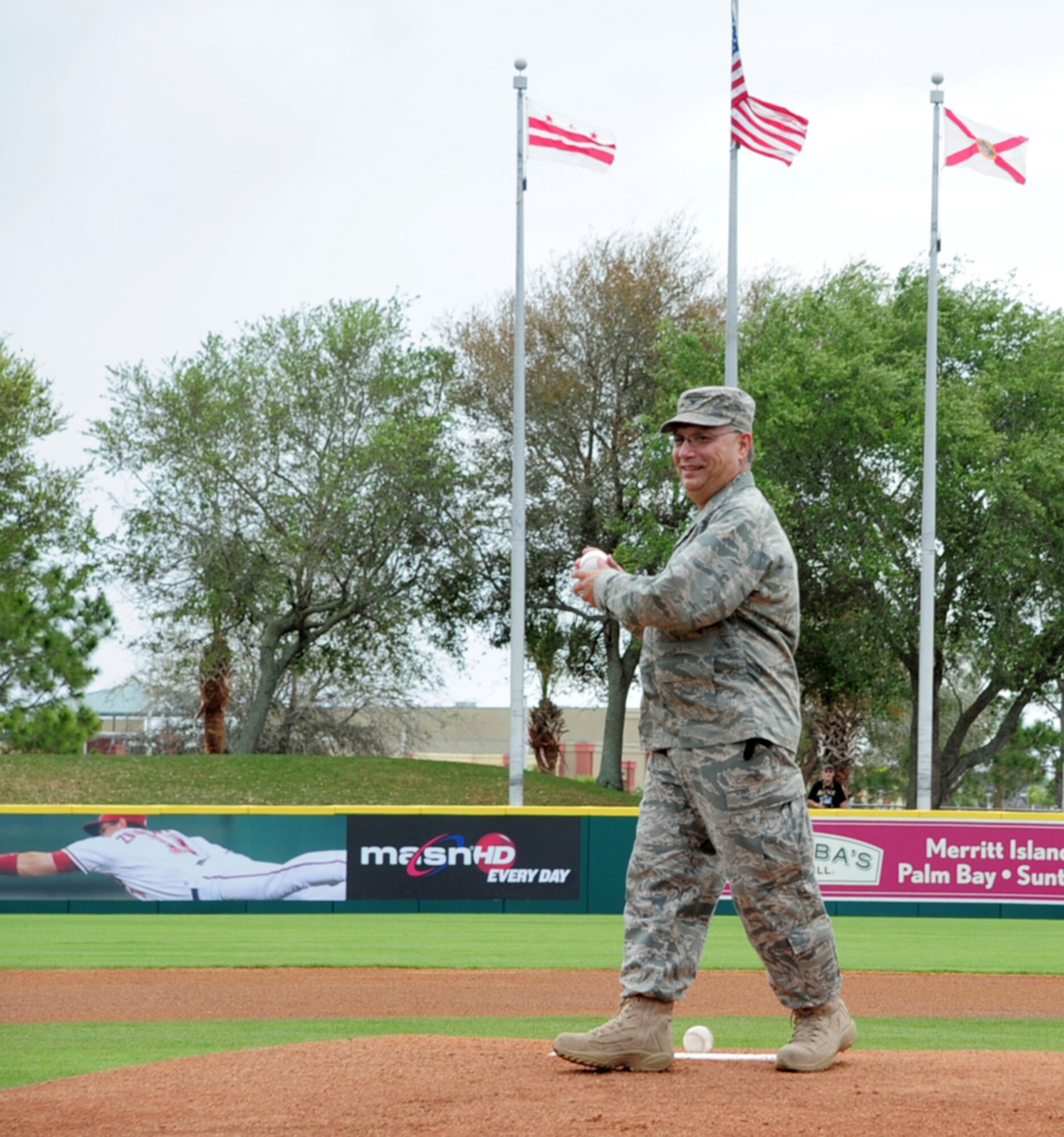 PATRICK AIR FORCE BASE, Fla. - Col. George Pierce, commander of maintenance for the 920th Rescue Wing, Air Force Reserve command, threw out the first pitch during a military appreciation day at the Space Coast Stadium in central Florida.  The Washington Nationals beat the Baltimore Orioles 5-4 during the spring training game that honored the local military.  Also, rescue crews piloted two HH-60G Pave Hawk helicopters from the 920th Rescue Wing here before the game then parked for display in a nearby field.  (U.S. Air Force Photo/Capt. Cathleen Snow)