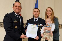 MINOT AIR FORCE BASE, N.D. -- Senior Airman Christopher McDonald, 791st Missile Security Forces Squadron, poses with his family after being awarded an Air Force Commendation Medal during a ceremony at the Jimmy Doolittle Center here March 20 for his actions Aug. 23, 2008, when he rendered assistance to individuals involved in a severe car accident. Airman McDonald performed cardiopulmonary resuscitation on the young girl who was injured in the accident and treated her for head wounds, ultimately saving her life. (U.S. Air Force photo by Senior Airman Kelly Timney)