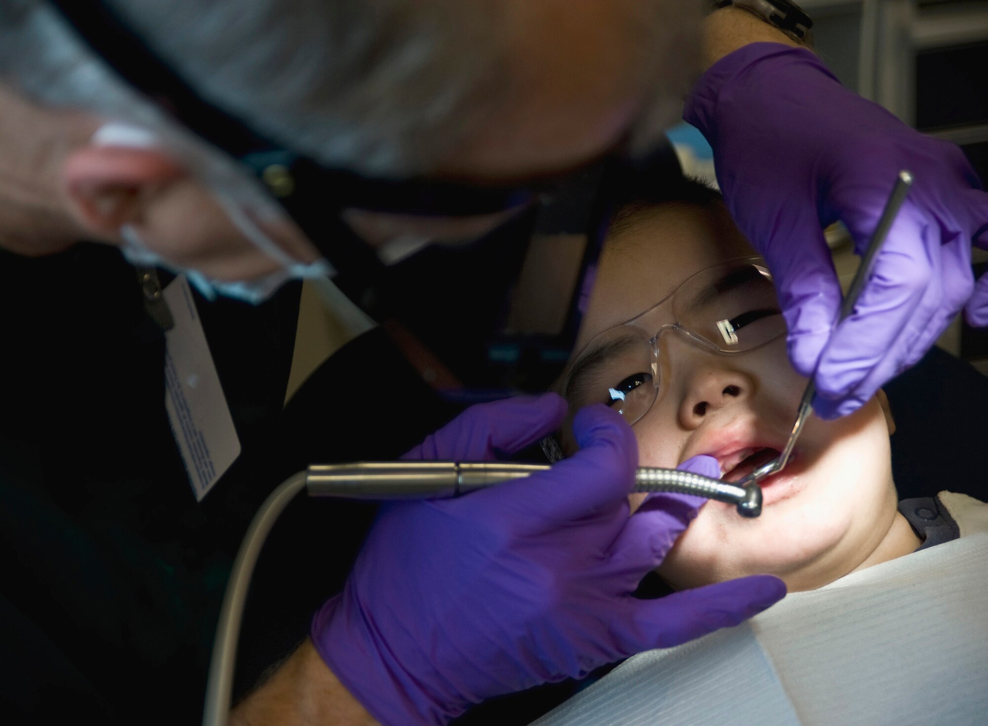 Navy Capt. Doug Henschel, a dentist from Fort Dix, N.J., inserts a filling for Dylon Sergie, 2, March 10 at a health clinic in Kwethluk, Alaska. A joint military medical team deployed to Kwethluk, a small village in Western Alaska, in support of Operation Arctic Care 2009. This year's Navy-led mission had teams in 11 villages in Alaska's Yukon-Kuskokwim Delta region providing medical, dental and veterinary support at no cost to Alaskan natives. (U.S. Air Force photo/Senior Airman Christopher Griffin)
