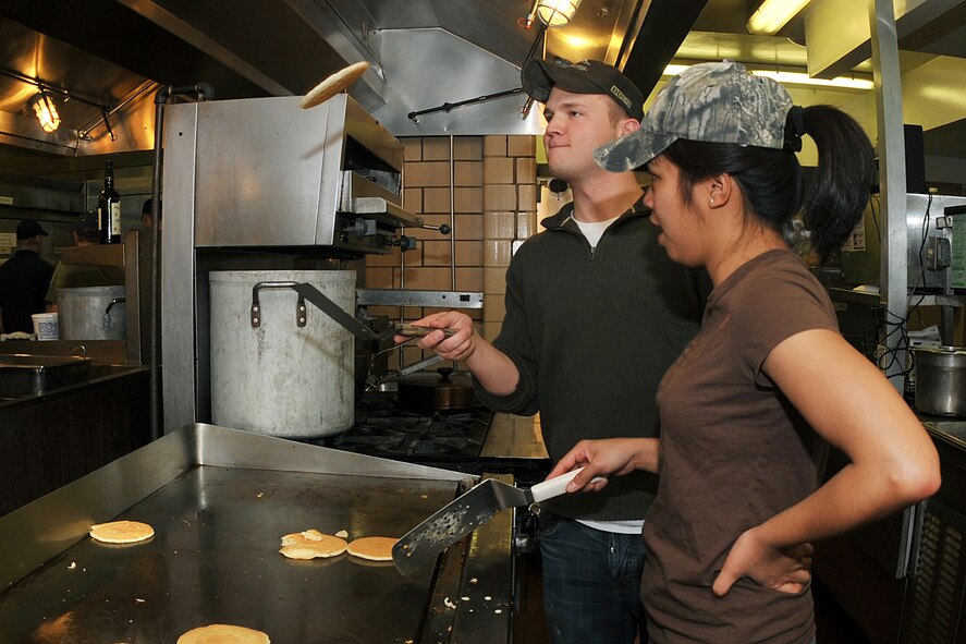 OFFUTT AIR FORCE BASE, Neb. -- Airman 1st Class Sonata Corpuz, 20th Intelligence Squadron, and Senior Airman Ryan Jureak, 338th Combat Training Squadron, flip pancakes during the Air Force Assistance Fund during a kick-off breakfast at the Patriot Club Mar. 17. The Air Force Assistance Fund was established as an annual effort to raise funds for the Air Force family the Air Force Village Foundation, Inc., the Air Force Aid Society, Inc., the Gen. and Mrs. Curtis E. LeMay Foundation, and the Air Force Enlisted Village.

U.S. Air Force Photo by Charles Haymond