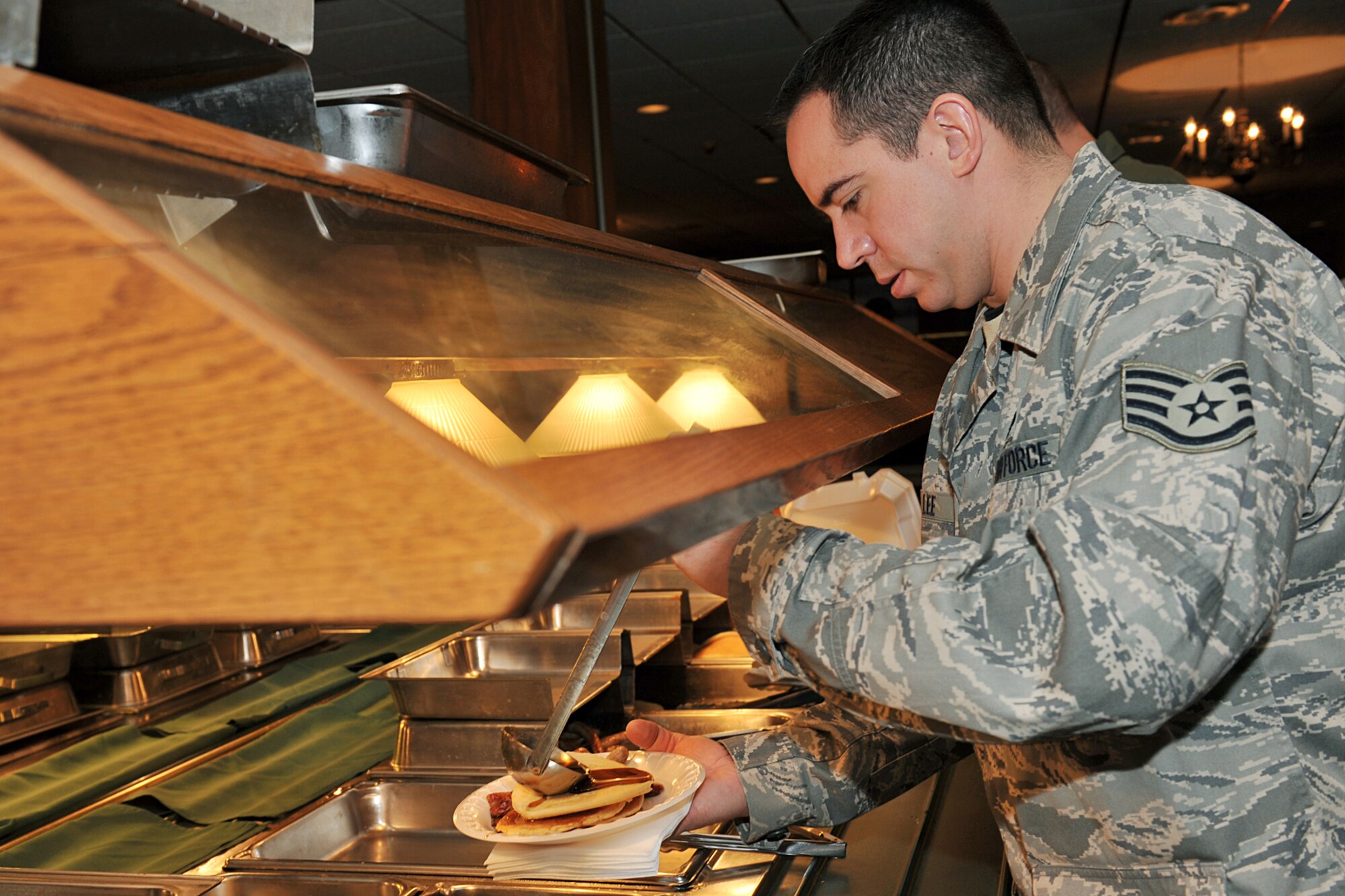 OFFUTT AIR FORCE BASE, Neb. -- Staff Sgt. Adam Lee, 55th Maintenance Squadron, pours syrup onto his pancakes during the Air Force Assistance Fund during a kick-off breakfast at the Patriot Club Mar. 17. The Air Force Assistance Fund was established as an annual effort to raise funds for the Air Force family the Air Force Village Foundation, Inc., the Air Force Aid Society, Inc., the Gen. and Mrs. Curtis E. LeMay Foundation, and the Air Force Enlisted Village. 

U.S. Air Force Photo by Charles Haymond