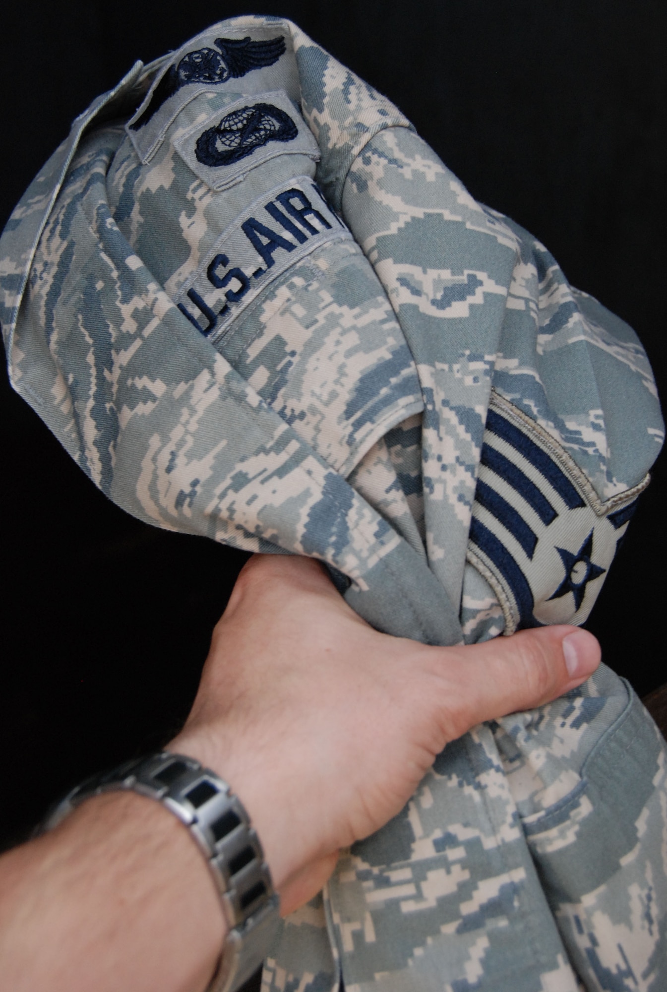 If a uniform is not donated, be sure to render it unserviceable before throwing it out.  Uniforms with rank, names or unit patches can be taken from garbage containers and used if not properly sanitized.  (U.S. Air Force photo illustration by Staff Sgt. Austin M. May)