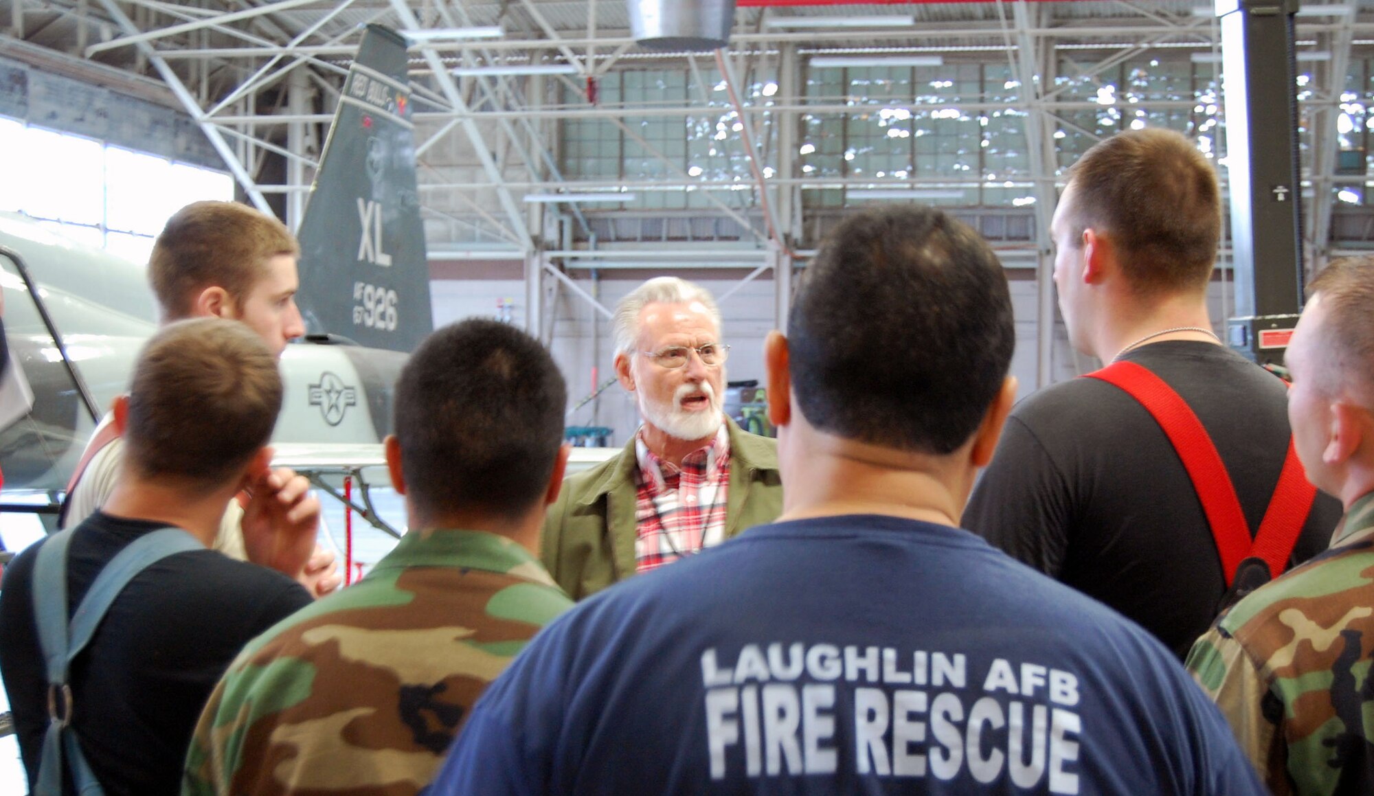 LAUGHLIN AIR FORCE BASE, Texas – On March 11th, Mr. Thomas L. Stemphoski, a fire protection egress specialist with Northrop Grumman, briefs Laughlin firefighters on a new model of ejection seat being fitted into the T-38.  The seats, derived from the model used in the Joint Strike Fighter, give pilots a better chance of surviving ejection without injury. Since the seats are powerful devices capable of firing a pilot three hundred feet into the air, firefighters train regularly to “safety” the aircraft, its fuel lines and its ejection seat to rescue pilots quickly and safely. (U.S. Air Force photo by 2d Lt Seth Pate)