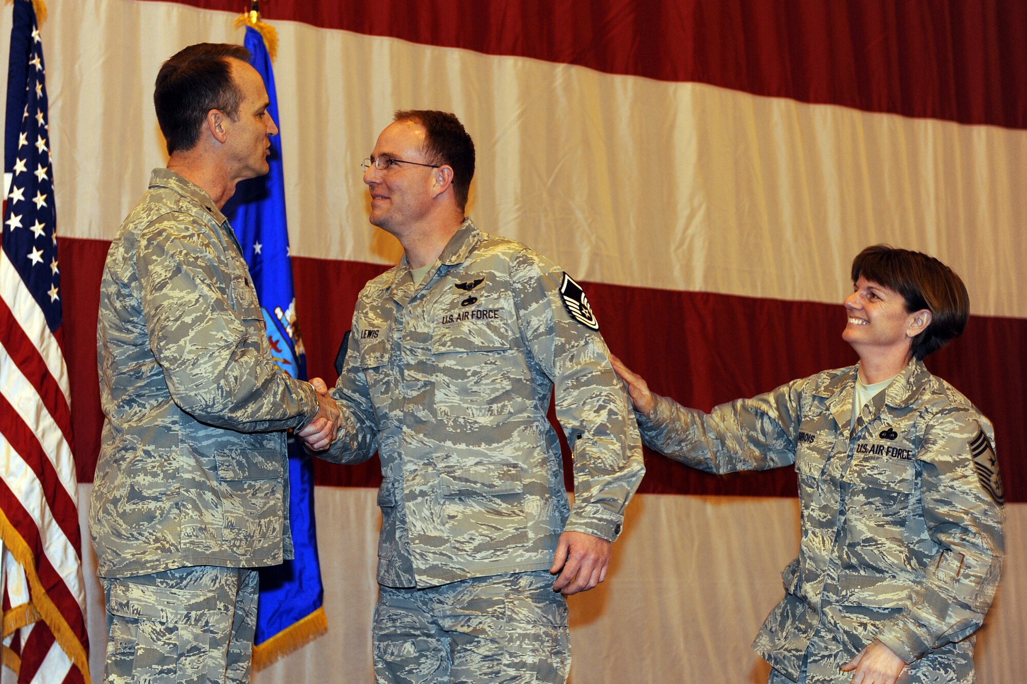 OFFUTT AIR FORCE BASE, Neb. -- Brig. Gen. James J. Jones, 55th Wing commander, congratulates Tech. Sgt. Troy Lewis, 55th Aircraft Maintenance Squadron, for a surprise STEP promotion during the 2009 Maintenance Professional of the Year award luncheon, Mar 13.  Tech. Sgt. Lewis was brought to the stage in front of his colleagues to be presented a wing coin, but was surprised with his new Master Sgt. stripes by the general and Command Chief Master Sgt. Lisa A. Sirois.

U.S. Air Force Photo by Josh Plueger
