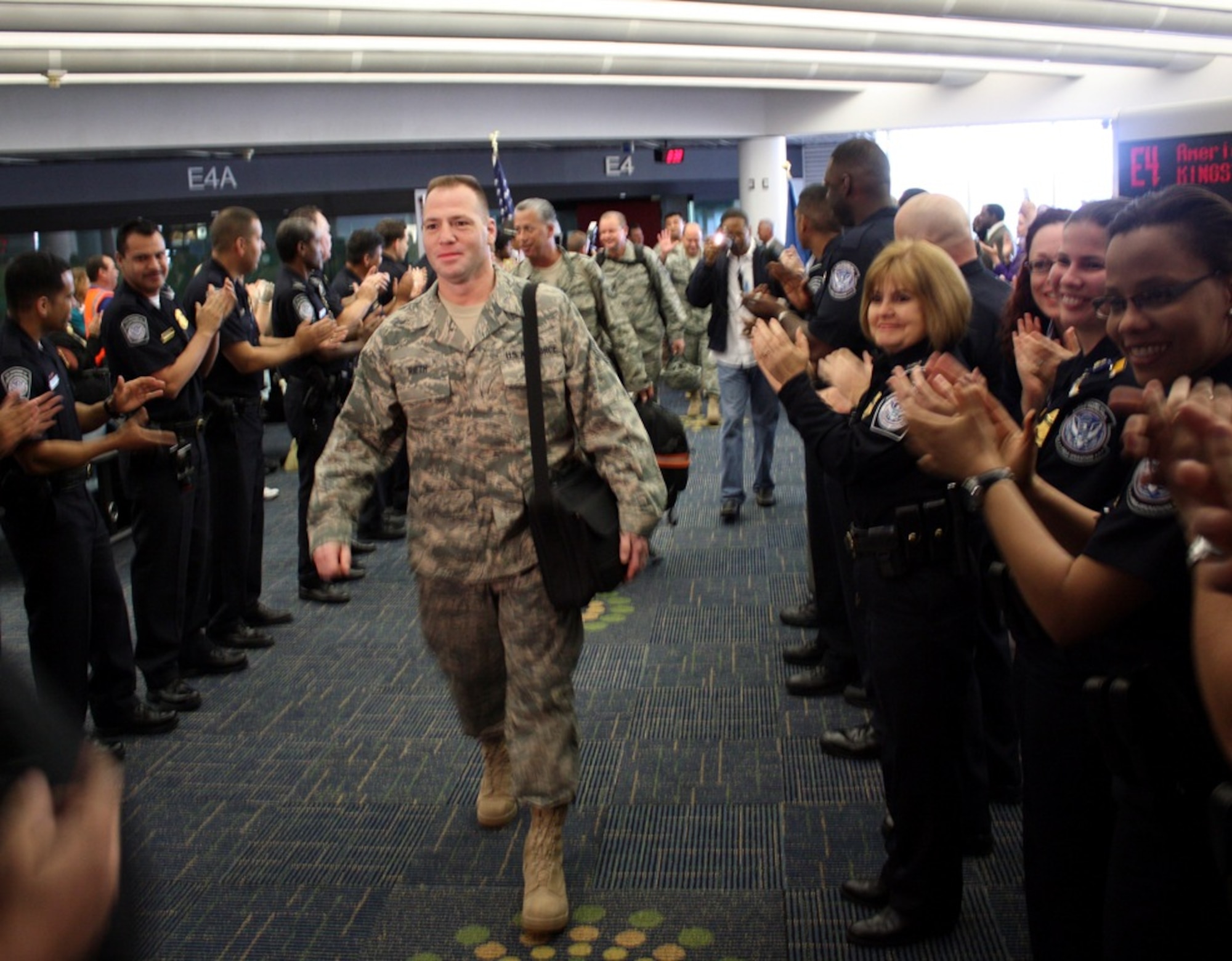 MIAMI, Fla. -- Master Sgt. Paul Rieth, 482nd Maintenance Squadron, and nine other reservists returned home from Iraq and were greeted with a reception coordinated by Miami International Airport and the office of Miami-Dade County Commissioner Jose "Pepe" Diaz. The Transportation Security Administration Honor Guard and U.S. Customs agents from the airport volunteered their time to participate in the homecoming. The reservists were deployed to Joint Base Balad, Iraq, to support U.S. and Coalition ground forces working to stabilize the country. F-16 fighter jets from Homestead ARB remain in Iraq, and reservists will continue to rotate in and out over the next two months. (U.S. Air Force photo/2nd Lt. Erik Hofmeyer) 