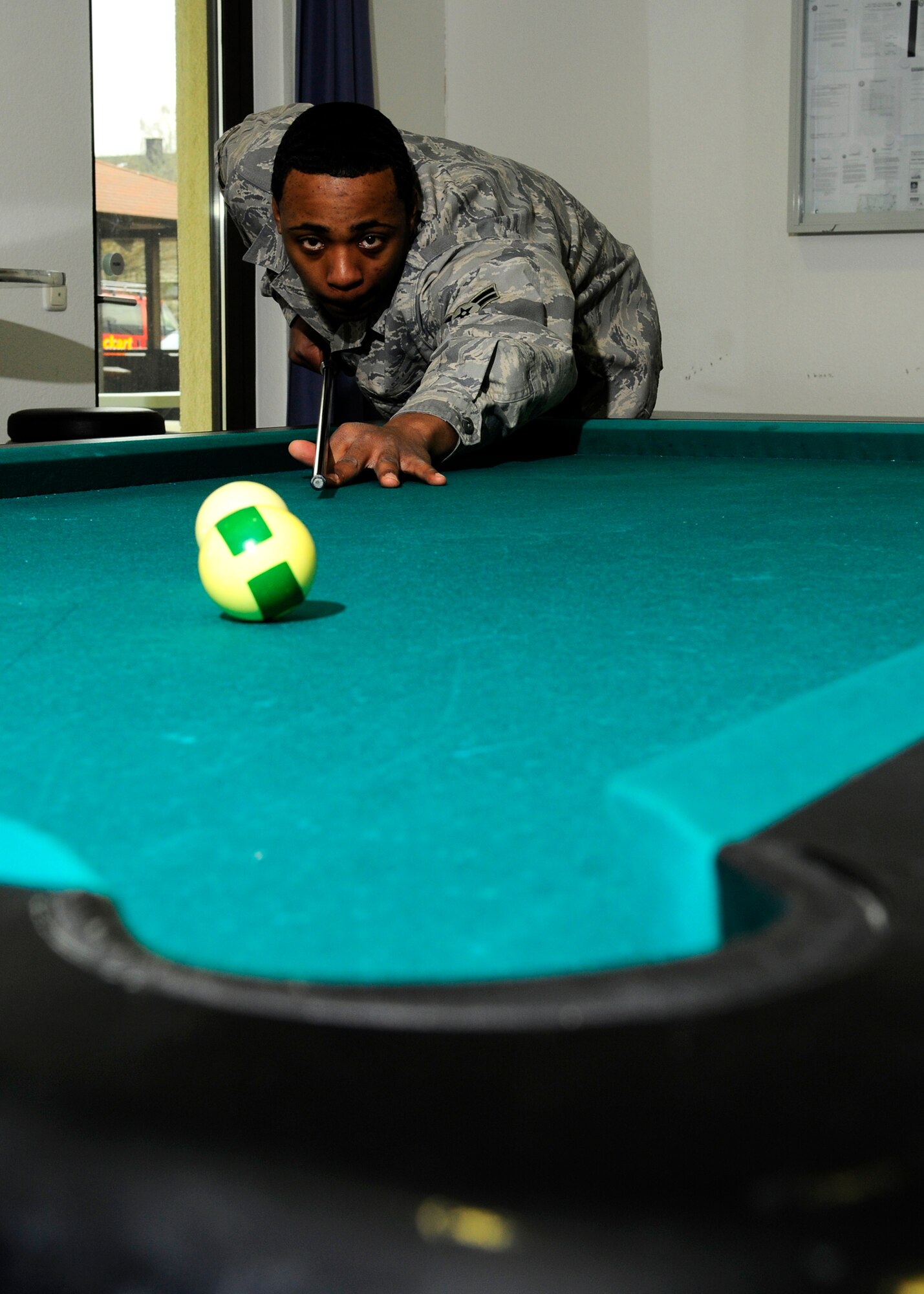 SPANGDAHLEM AIR BASE, Germany – Airman 1st Class Justin Jackson, 52nd Communications Squadron postal worker, shoots pool during his break March 19, 2009. (U.S. Air Force photo by Senior Airman Allen Pollard)