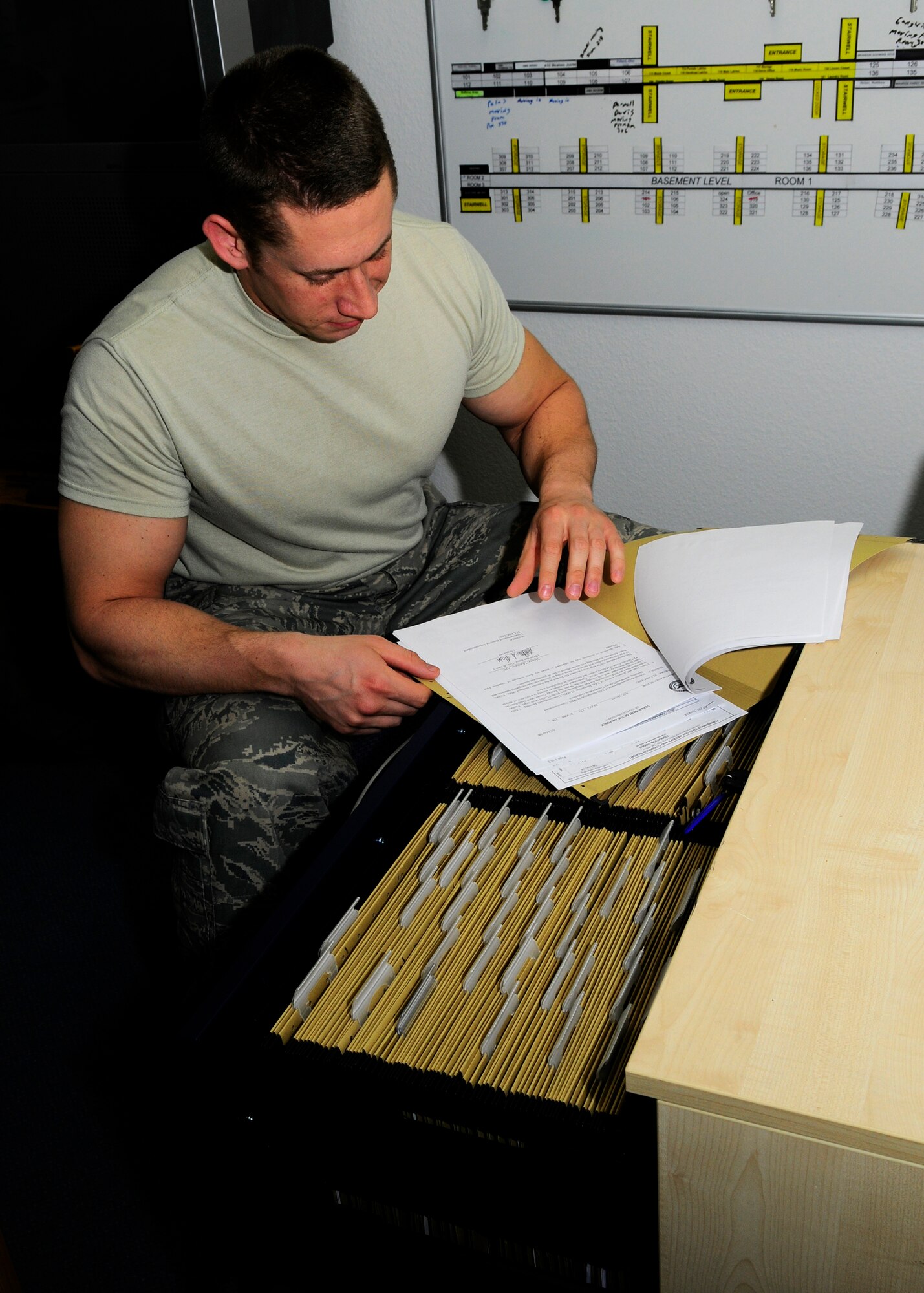 SPANGDAHLEM AIR BASE, Germany – Staff Sgt. Adam Gerhart, 52nd Civil Engineer Squadron dorm manger, organizes files and information regarding dorm occupants March 19, 2009. Dorm managers are responsible for assigning rooms to inbound single and unaccompanied Airmen.  (U.S. Air Force photo by Senior Airman Allen Pollard)