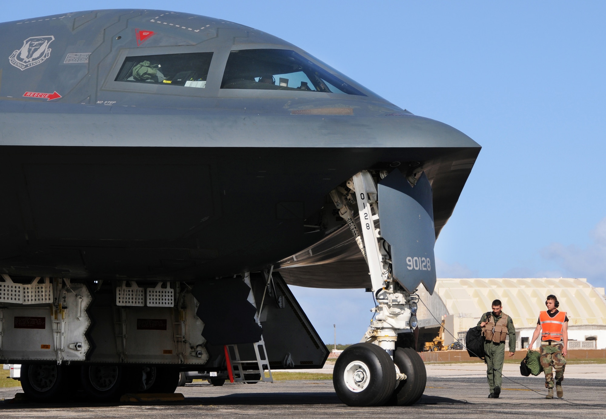 Airman 1st Class Joshua Silva walks with a B-2 Spirit pilot during an engine-running crew swap during Exercise Polar Lightning March 12 at Andersen Air Force Base, Guam. B-2s are deployed here from Whiteman AFB, Mo., as part of a regularly scheduled air and space expeditionary force rotation to the Pacific. Airman Silva is a 36th Expeditionary Maintnenance Squadron crew chief. (U.S. Air Force photo/Senior Airman Ryan Whitney) 
