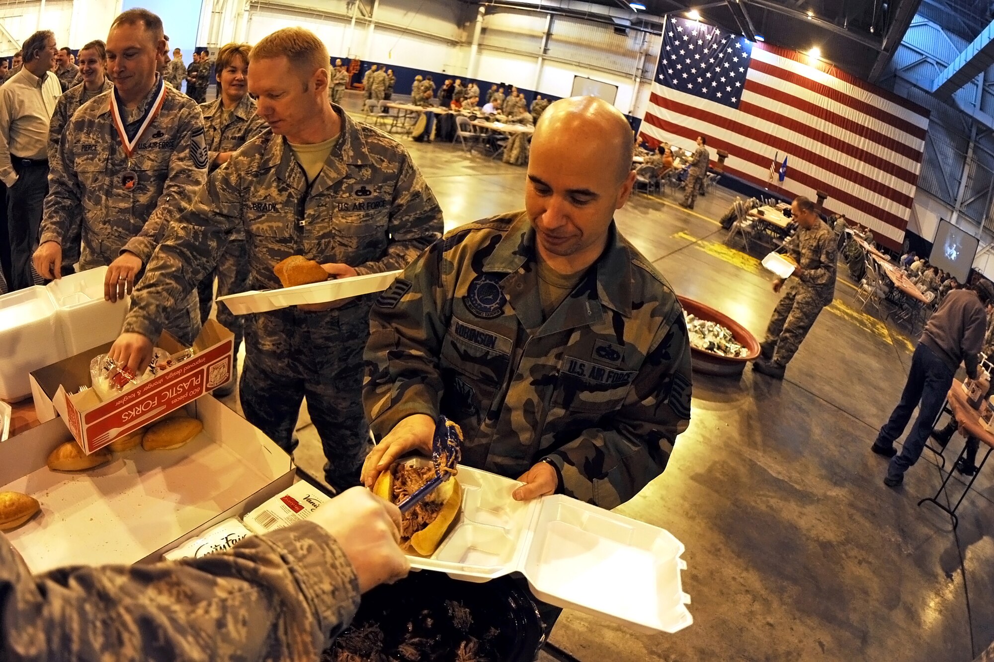 OFFUTT AIR FORCE BASE, Neb. -- Tech. Sgt. David Robinson,  55th Maintenance Squadron Repair and Reclamation, gets a barbeque sandwich, and a couple of side dishes during the 2009 Maintenance Professional of the Year luncheon held in Dock One of the Bennie Davis Maintenance Facility Mar 13. The ceremony formally recognizes the men and women of the 55th Maintenance Group for their exemplarily work throughout the year in numerous categories.

U.S. Air Force Photo by Josh Plueger
