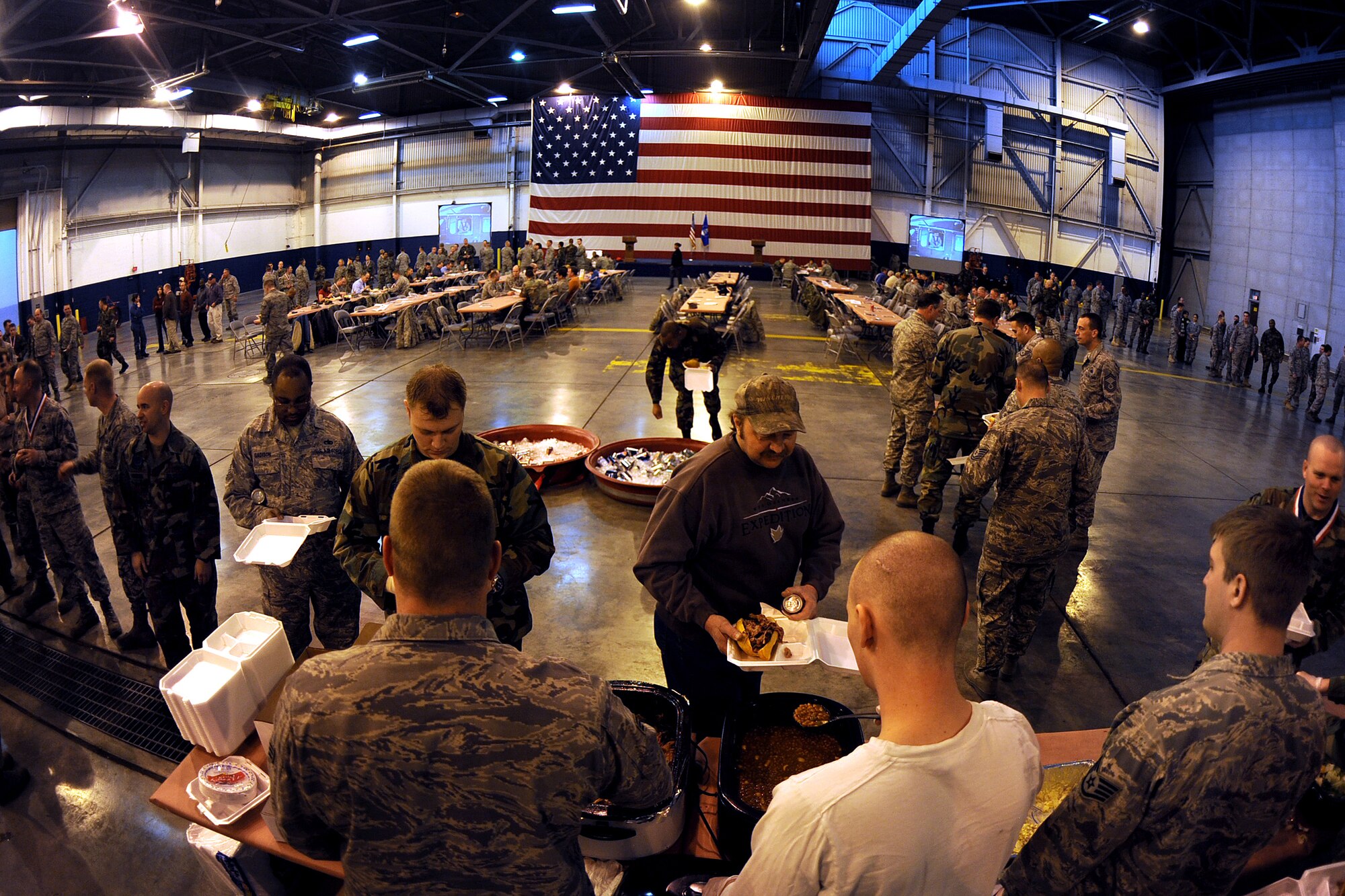 OFFUTT AIR FORCE BASE, Neb.-- Lines form inside of the Bennie Davis Maintenance Facility's Dock One, as members of the 55th Maintenance Group wait for barbeque sandwiches, and an array of side dishes as part of the annual Maintenance Professional of the Year luncheon, Mar 13. The ceremony formally recognizes the men and women of the 55th MXG for their exemplarily work throughout the year.

U.S. Air Force Photo by Josh Plueger
