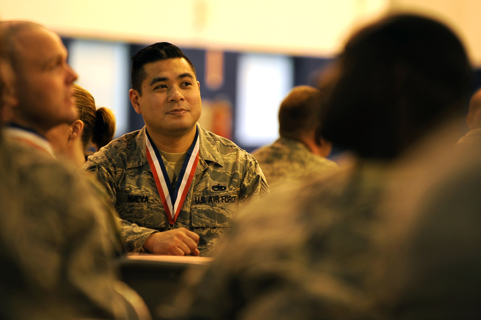 OFFUTT AIR FORCE BASE, Neb. -- Tech. Sgt. Richard Nueva, 55th Maintenance Operations Squadron, listens to the guest speaker while eating lunch inside of Dock One of the Bennie Davis Maintenance Facility as part of the 2009 Maintenance Professional of the Year awards luncheon.  Tech. Sgt. Nueva and numerous other maintenance professionals were given medals to wear at the ceremony indicating they were a finalist in their selected categories.

U.S. Air Force Photo by Josh Plueger
