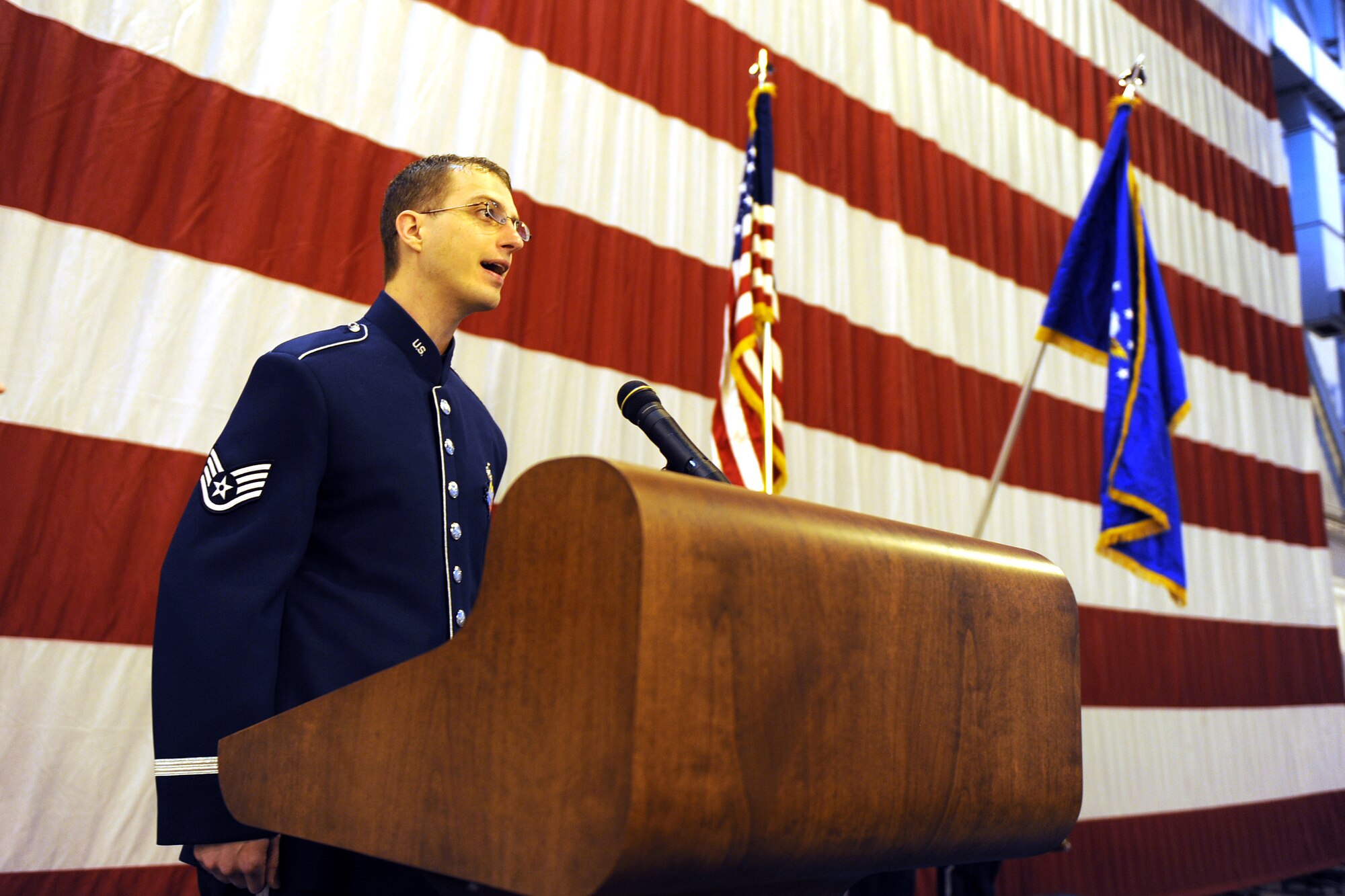 OFFUTT AIR FORCE BASE, Neb. -- Staff Sgt. Clint Whitney, vocalist for the Heartland of America Band?s Night Wing ensemble, sing the national anthem inside of the Bennie Davis Maintenance Facility's Dock One to start the 2009 Maintenance Professional of the Year awards luncheon Mar 13.  The awards ceremony honors the men and women of the 55th Maintenance Group for their exemplarily work throughout the year.

U.S. Air Force Photo by Josh Plueger
