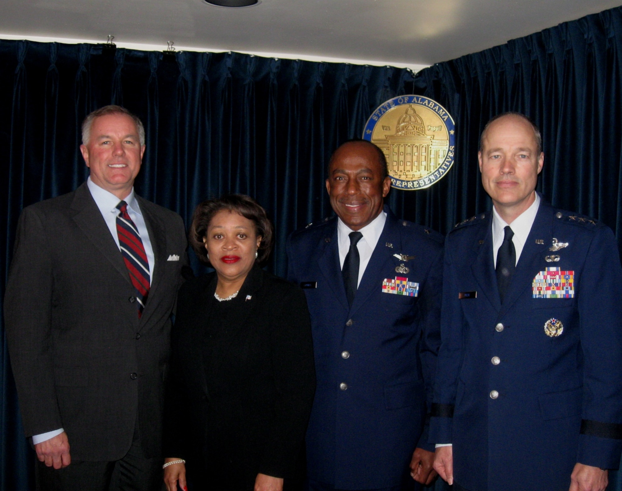 Brig. Gen. Edward F. Crowell (second from right) was honored March 12 by a joint resolution from both houses of the Alabama Legislature. The resolution honored General Crowell for his Reserve military service career that began as an Airman Basic in the 908th Airlift Wing located at Maxwell. Leaving the 908th as a colonel after 23 years, General Crowell served at two numbered Air Forces before returning to Maxwell as the mobilization assistant to the Air University commander. General Crowell completed his 35-year career retiring at Maxwell Feb. 4. Shown from left are Rep. Greg Wren , Mrs. Ernestine Crowell, General Crowell, and Air University Commander Lt. Gen. Allen G. Peck. (Courtesy photo)
