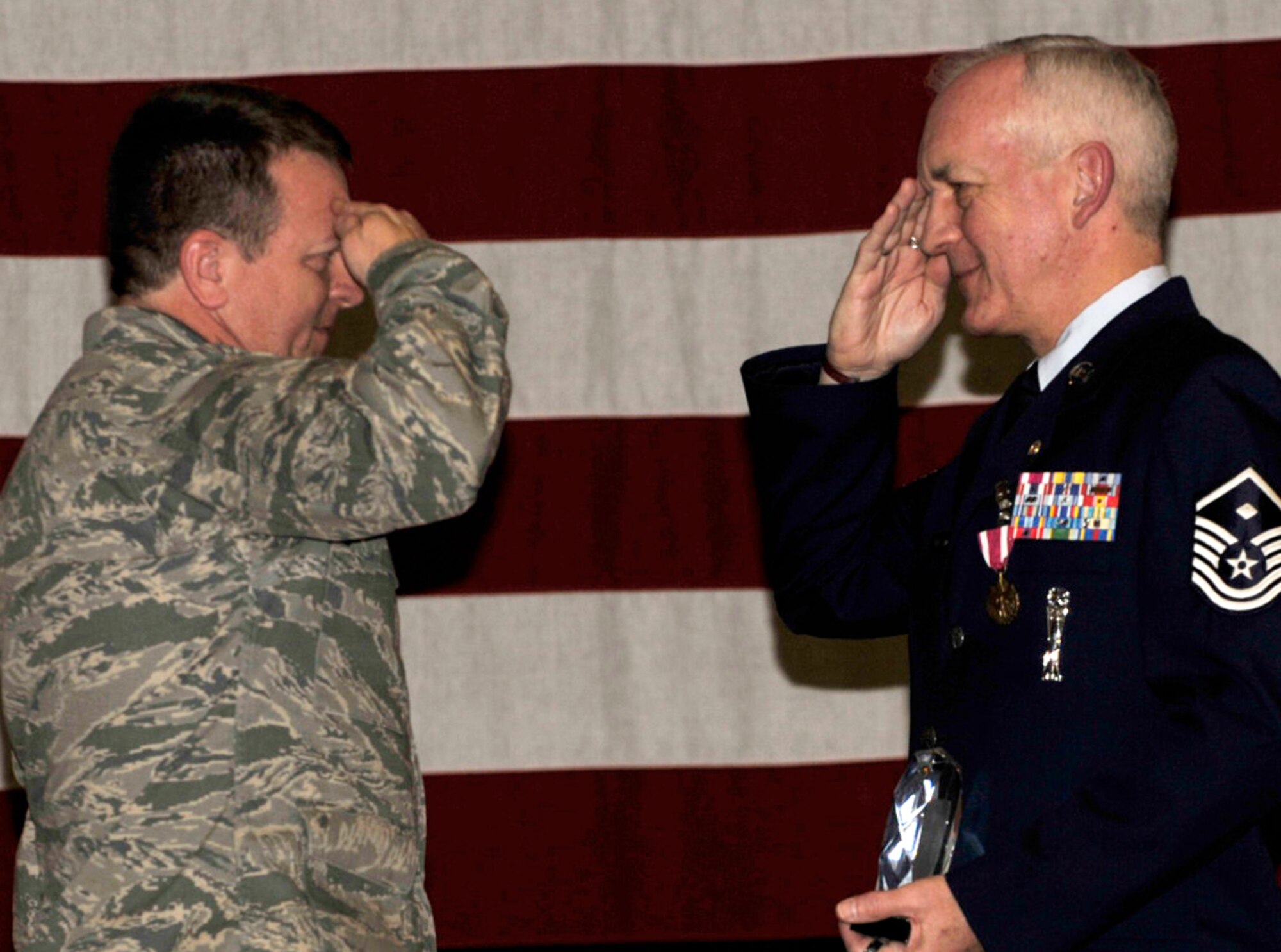 Master Sgt. Robert Livingston (on right) salutes Col. Edsel "Archie" Frye Jr. following the presentation of a Kanza roach crystal during Sergeant Livingston's retirment ceremony on March 15. The crystal is presented to retirees who are also charter members of the 931s Air Refueling Group. Sergeant Livingston is the 931st's second charter member. Colonel Frye is commander of the 931st ARG. (U.S. Air Force photo/Tech. Sgt. Jason Schaap)
