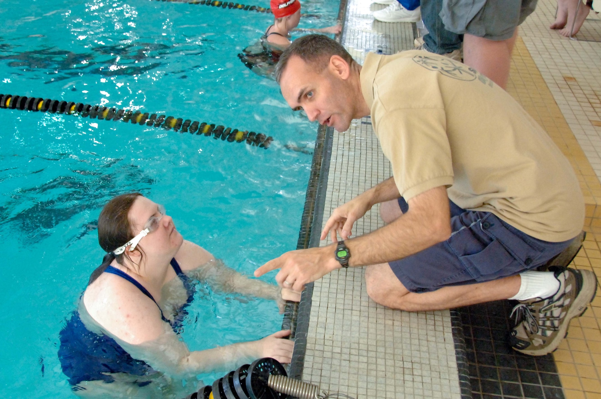 Special Olympics swimmer Tiffany Capistran, of the Montgomery Blue Marlins team, gets words of advice from Chap. (Maj.) Kleet Barclay during a swim meet at Alabama State University March 13. The staff of Gunter's Enlisted Heritage Research Institute, the Holm and Barnes Centers and the 42nd Air Base Wing volunteered their assistance for the event, which in addition to the Blue Marlins, drew swimming teams from Dothan, Mobile, Gadsden and Tuscaloosa, Ala. (U.S. Air Force photo by Donna L. Burnett)