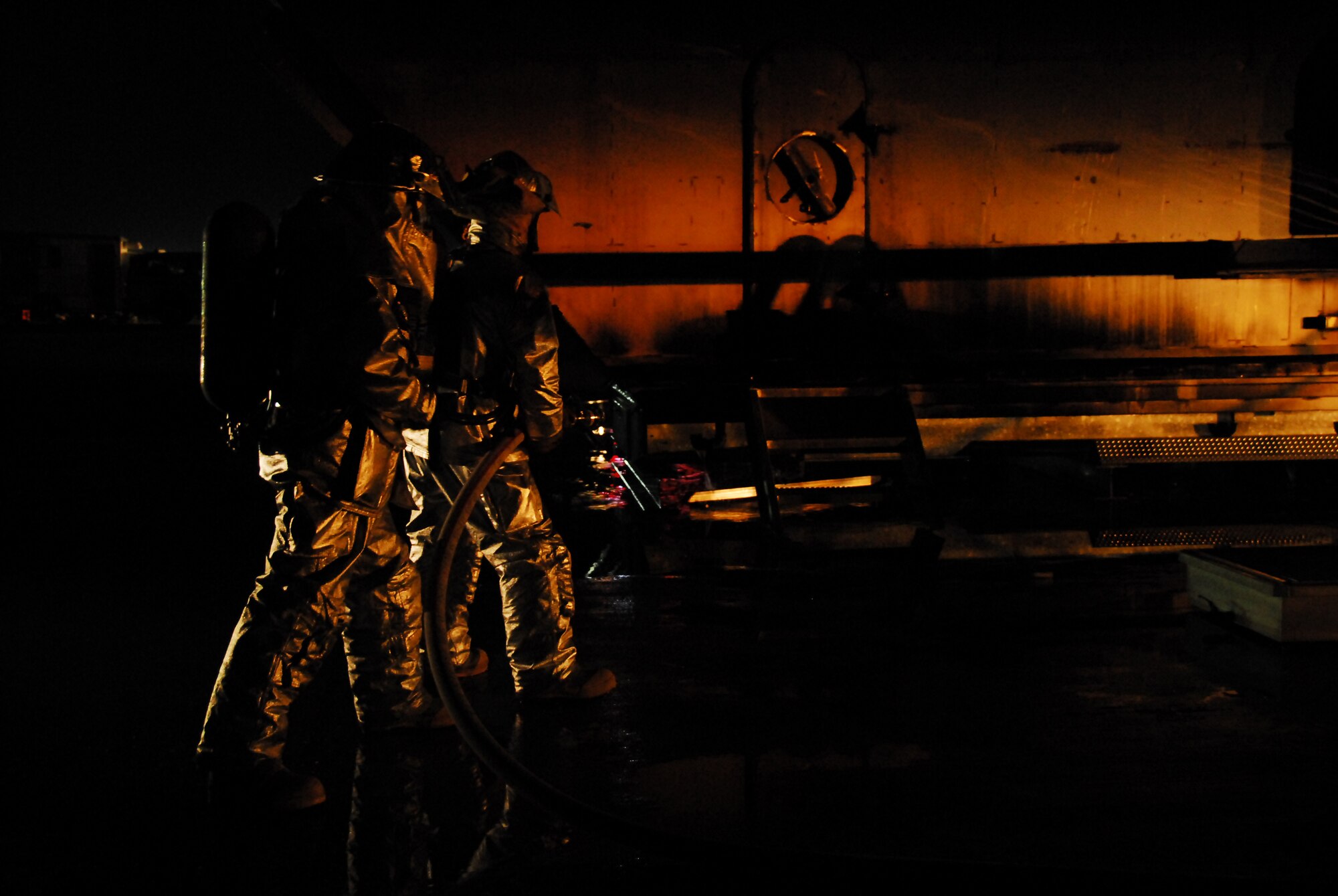 SOUTHWEST ASIA -- Firefighters from the 386th Expeditionary Civil Engineer Squadron wait to provide back up for fellow firefighters during live fire burn training at an Army base in Southwest Asia, March 18. Teamwork plays a very important role for firefighters; they must depend on each other to not only save the lives of others but themselves as well. (U.S. Air Force photo/ Senior Airman Courtney Richardson) 