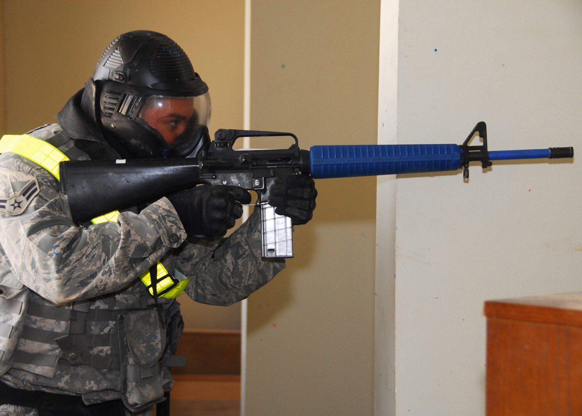 SOUTHWEST ASIA -- Airman 1st Class David Puma, 386th Expeditionary Security Forces Squadron, prepares to engage the incoming building sweep team during a Close Quarter Battle Drill at an air base in Southwest Asia, March 18. During this training the Airmen were given the opportunity to use simulation rounds, 9mm casings with paintball tips. Airman Puma is currently deployed from Sheppard Air Force Base, Texas and is originally from Chicago. (U.S. Air Force photo/ Senior Airman Courtney Richardson)