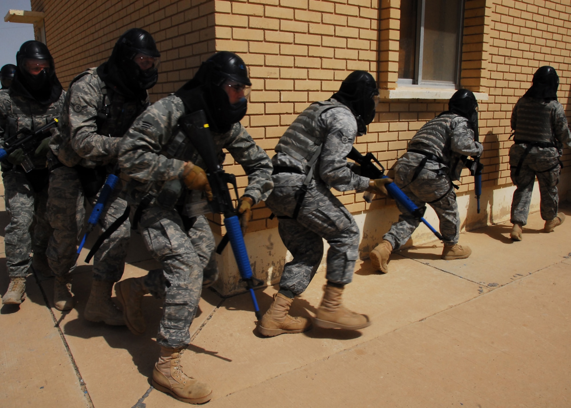 SOUTHWEST ASIA -- Airmen from the 386th Expeditionary Security Forces Squadron move in fire teams while performing a building sweep during a Close Quarter Battle drill at an air base in Southwest Asia, March 18. The CQB drills allow the Airmen to improve their tactics, vigilance and teamwork. (U.S. Air Force photo/ Senior Airmen Courtney Richardson)