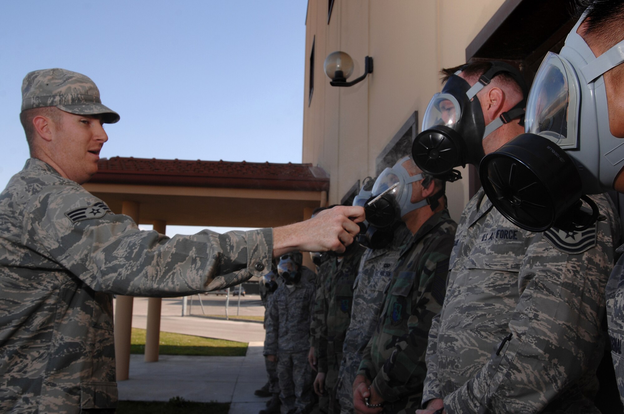Senior Airman Christopher Gapetz, a 31st Civil Engineer Squadron readiness and emergency management journeyman, uses a ventilation smoke tube to test the mask confidence of Air Force members during Chemical, Biological, Radiological, Nuclear, and High Yield Explosives survival skills training March 19, here. The Readiness and Emergency Management flight holds the required CBRNE survival skills training classes approximately three times a week with 20-30 people in a class at a time. (U.S. Air Force photo/ Staff Sgt. Patrick Dixon)