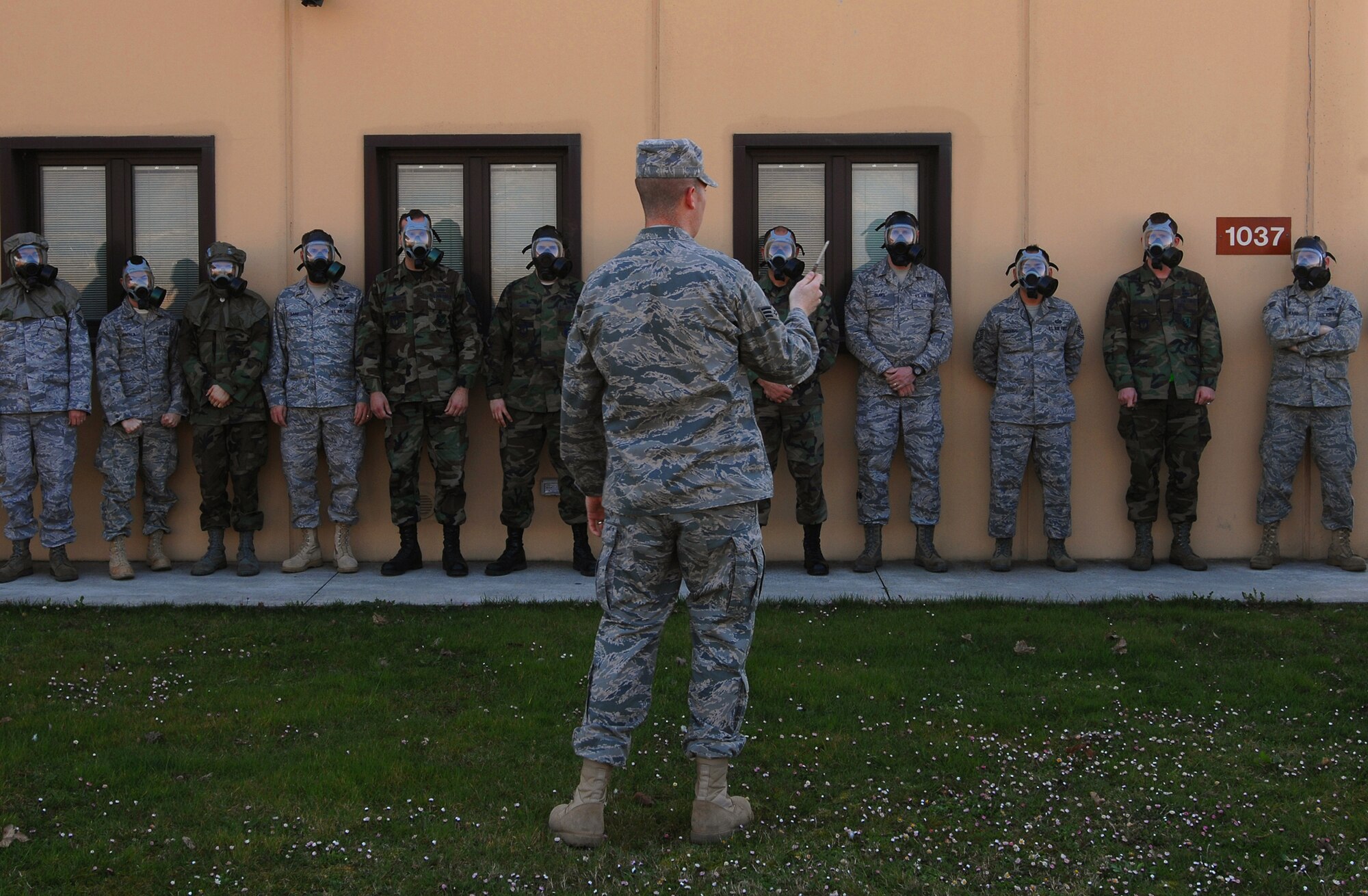 Senior Airman Christopher Gapetz (center), a 31st Civil Engineer Squadron readiness and emergency management journeyman, prepares to use a ventilation smoke tube to test the mask confidence of Air Force members during Chemical, Biological, Radiological, Nuclear, and High Yield Explosives survival skills training March 19, here. The Readiness and Emergency Management flight holds the required CBRNE survival skills training classes approximately three times a week with 20-30 people in a class at a time. (U.S. Air Force photo/ Staff Sgt. Patrick Dixon)
