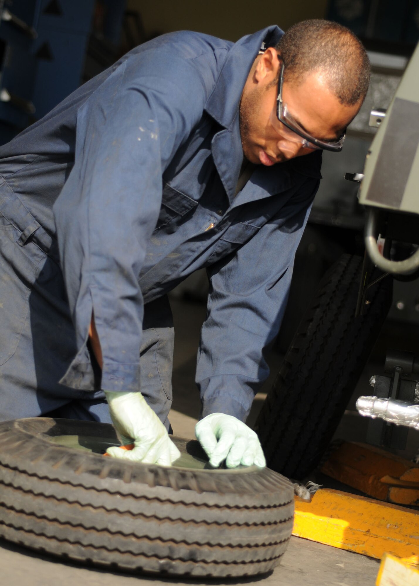 YOKOTA AIR BASE, Japan -- Airman 1st Class Ronald Mathews, 374th Maintenance Squadron aerospace ground equipment apprentice, inspects wheel bearings March 19. The AGE flight maintains more than 600 pieces of equipment and supplies ground power to aircraft and maintenance crews to help them troubleshoot and repair aircraft. (U.S. Air Force photo/Senior Airman Veronica Pierce) 
