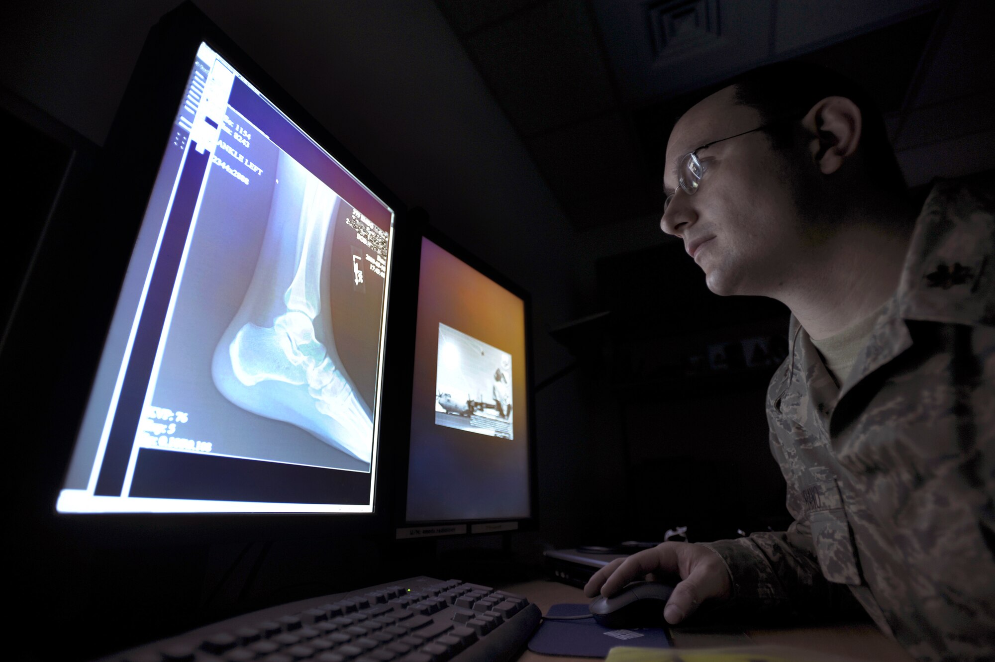 Major Jerry Suriano, a Doctor with the 379th Expeditionary Medical Group, reviews a patient?s foot x-ray, Mar. 18, 2009, in an undisclosed location in Southwest Asia.  Major Suriano is native to Carol Stream, Ill. and is deployed from Andrews Air Force Base, M.D. in support of Operations Iraqi and Enduring Freedom and Combined Joint Task Force - Horn of Africa.  (U.S. Air Force Photo by Staff Sgt. Joshua Garcia/released) 