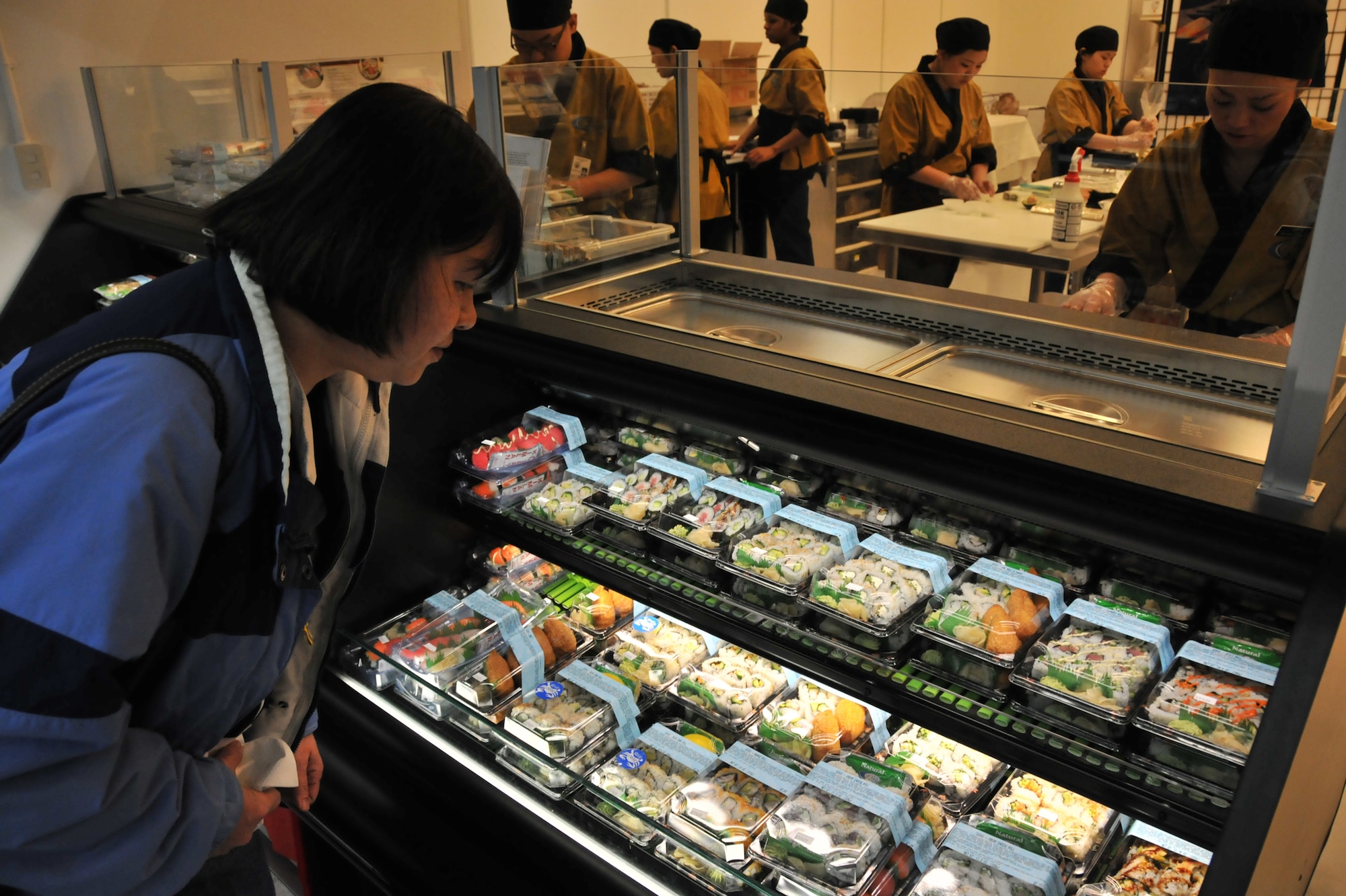 MISAWA AIR BASE, Japan -- A customer browses the selection of sushi during the grand opening of the commissary sushi bar March 14, 2009. Trainers were brought in to teach employees how to make and prepare the sushi. (U.S. Air Force photo by Capt. Kenneth Gerst)