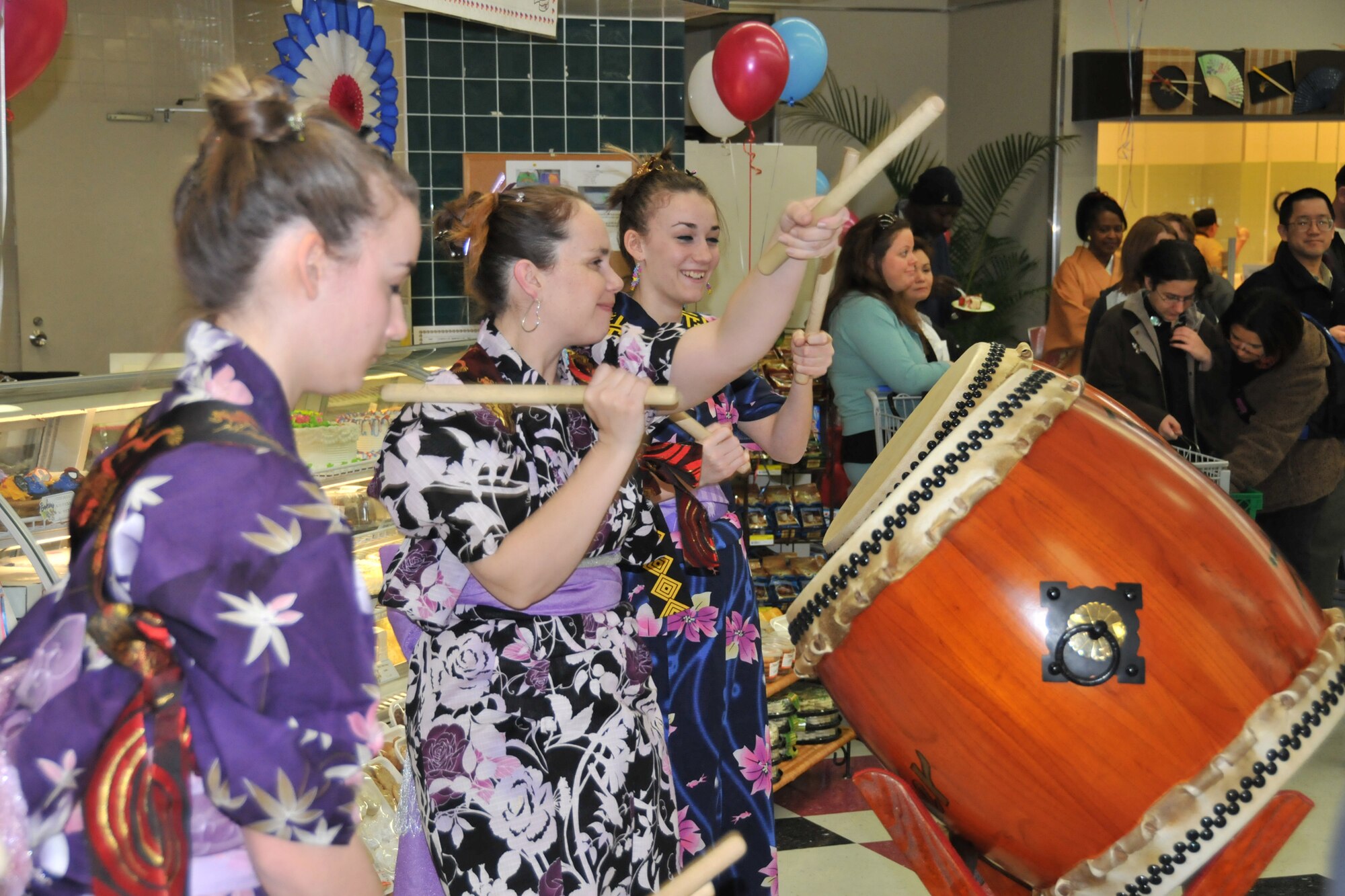MISAWA AIR BASE, Japan -- Members of the Dragon-Eagle Taiko drum team perform during the grand opening of the commissary sushi bar March 14, 2009. In addition to a musical performance, commissary customers were treated to prize give-aways and free samples of sushi. (U.S. Air Force photo by Capt. Kenneth Gerst)