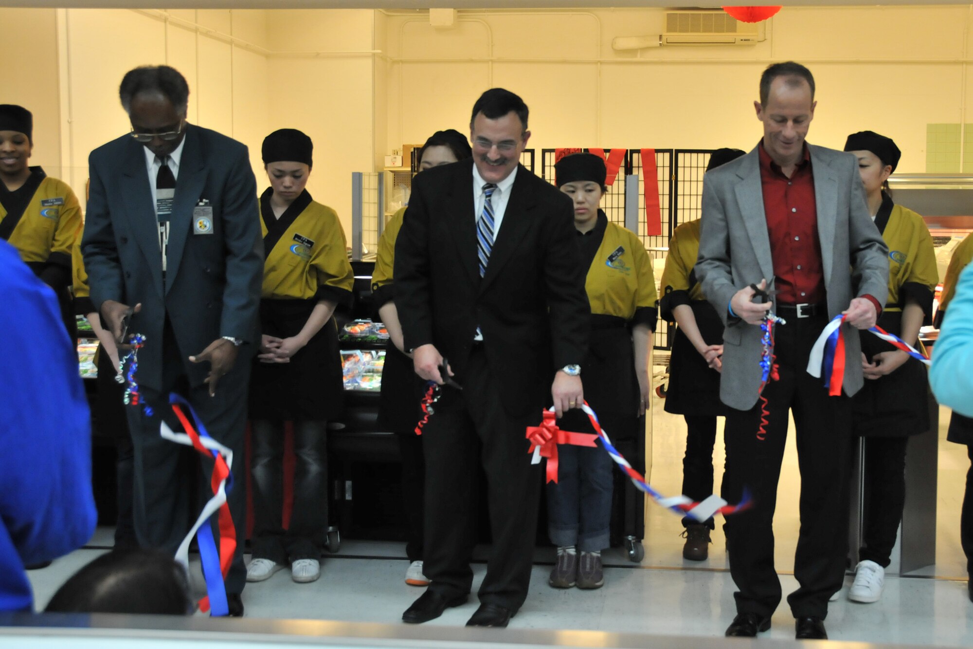 MISAWA AIR BASE, Japan -- Gregory McGruder, Frank Pecoraro, and Col. David Stilwell, 35th Fighter Wing commander, take part in a ribbon cutting ceremony March 14, 2009. Mr. McGruder, commissary store director, and Mr. Pecoraro, Coastal Pacific Food Distributors president and chief executive officer, worked together to bring sushi to the Misawa Air Base commissary. (U.S. Air Force photo by Capt. Kenneth Gerst)
