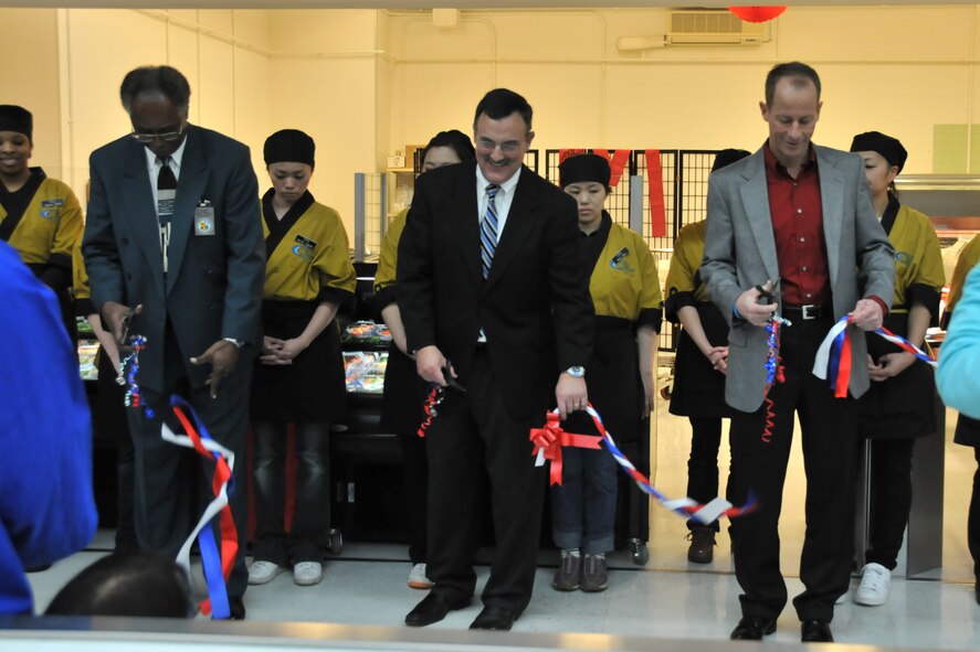 MISAWA AIR BASE, Japan -- Gregory McGruder, Frank Pecoraro, and Col. David Stilwell, 35th Fighter Wing commander, take part in a ribbon cutting ceremony March 14, 2009. Mr. McGruder, commissary store director, and Mr. Pecoraro, Coastal Pacific Food Distributors president and chief executive officer, worked together to bring sushi to the Misawa Air Base commissary. (U.S. Air Force photo by Capt. Kenneth Gerst)