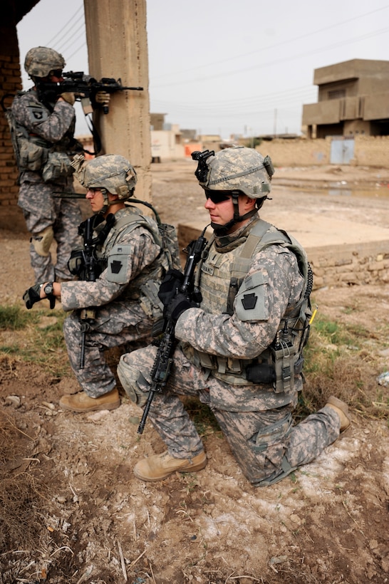 U.S. soldiers conduct a dismounted patrol through the northeastern ...