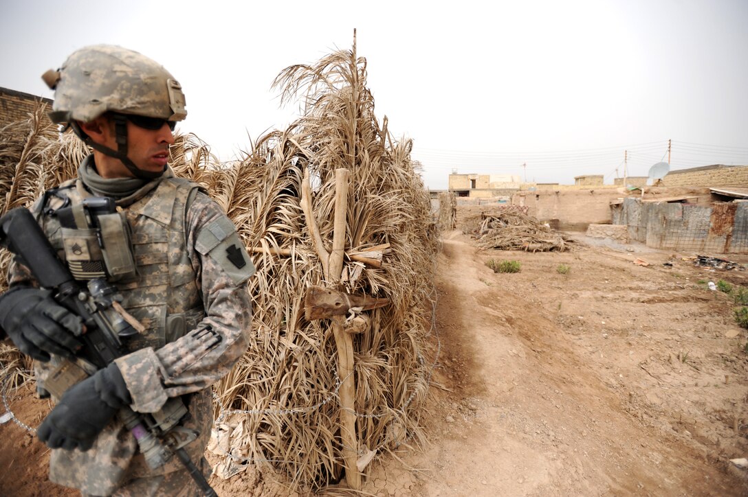 U.S. Army Staff Sgt. Matthew Kilner checks around a corner while providing security on a dismounted patrol through the northeastern section of the city of Tarmiyah, Iraq, March 13, 2009. Kilner is assigned to Company C, 1st Battalion, 111th Infantry Regiment, 56th Stryker Brigade Combat Team, 28th Infantry Division, Pennsylvania National Guard, Multinational Division Baghdad.