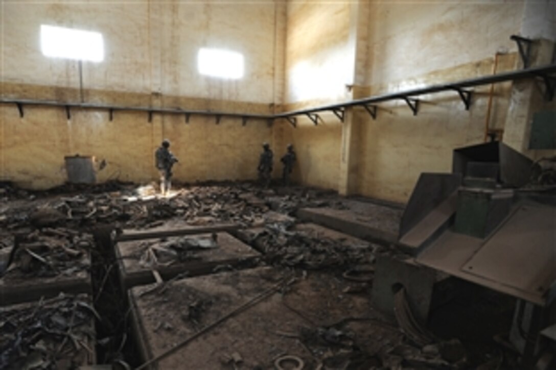 U.S. soldiers inspect a warehouse filled with empty rocket and artillery casings at the old Nasser Weapons Manufacturing Plant during a site survey mission near the city of Taji, Iraq, March 18, 2009. The soldiers are assigned to Alpha Company, 1st Battalion, 111th Infantry Regiment (Associators), 56th Stryker Brigade Combat Team, 28th Infantry Division, Multi-National Division Baghdad.