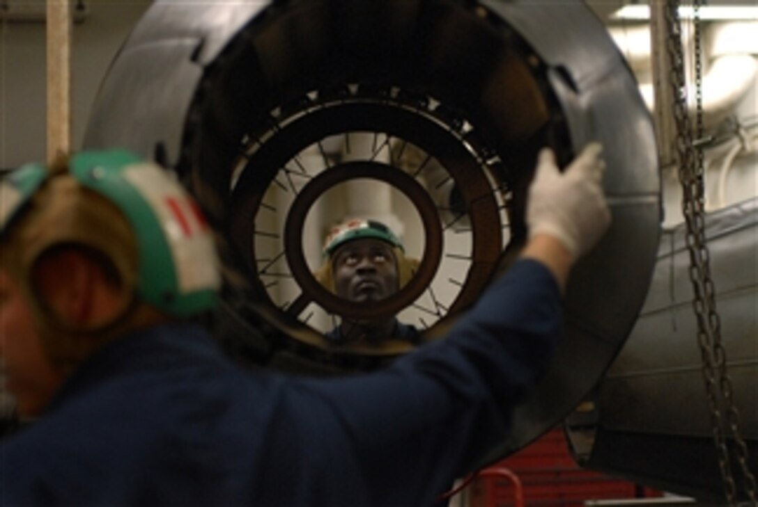 090313-N-2344B-085 
      U.S. Navy Petty Officer 3rd Class Benjamin K. Darkwah directs the movement of an F-404 engine from an F/A-18 Hornet aircraft in the jet shop aboard the aircraft carrier USS Ronald Reagan (CVN 76) in the Pacific Ocean on March 13, 2009.  The engine is being moved to an afterburner stand so a high-pressure compressor module can be dismantled and replaced.  The Ronald Reagan and Carrier Air Wing 14 are underway performing a sustainment exercise.  